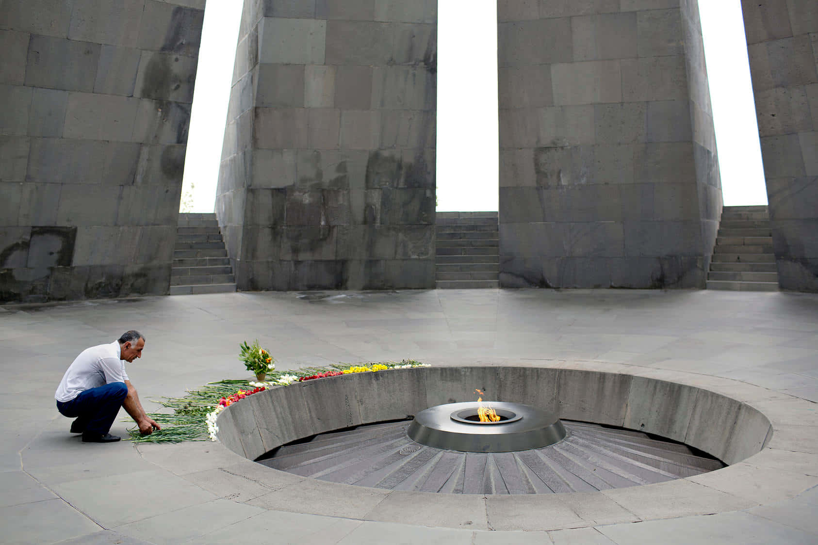 Man Offering Flowers Armenian Genocide Memorial Background
