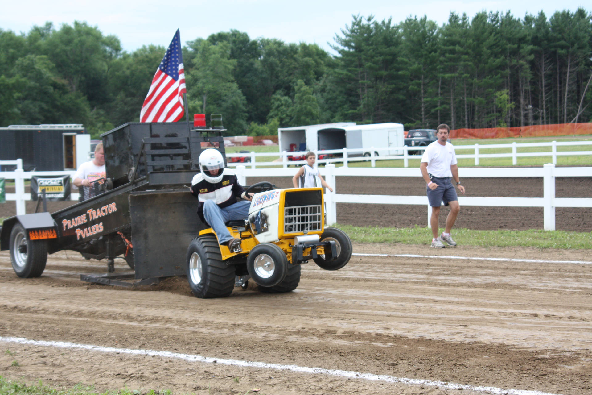 Man Operating A Yellow Tractor In The Field Background