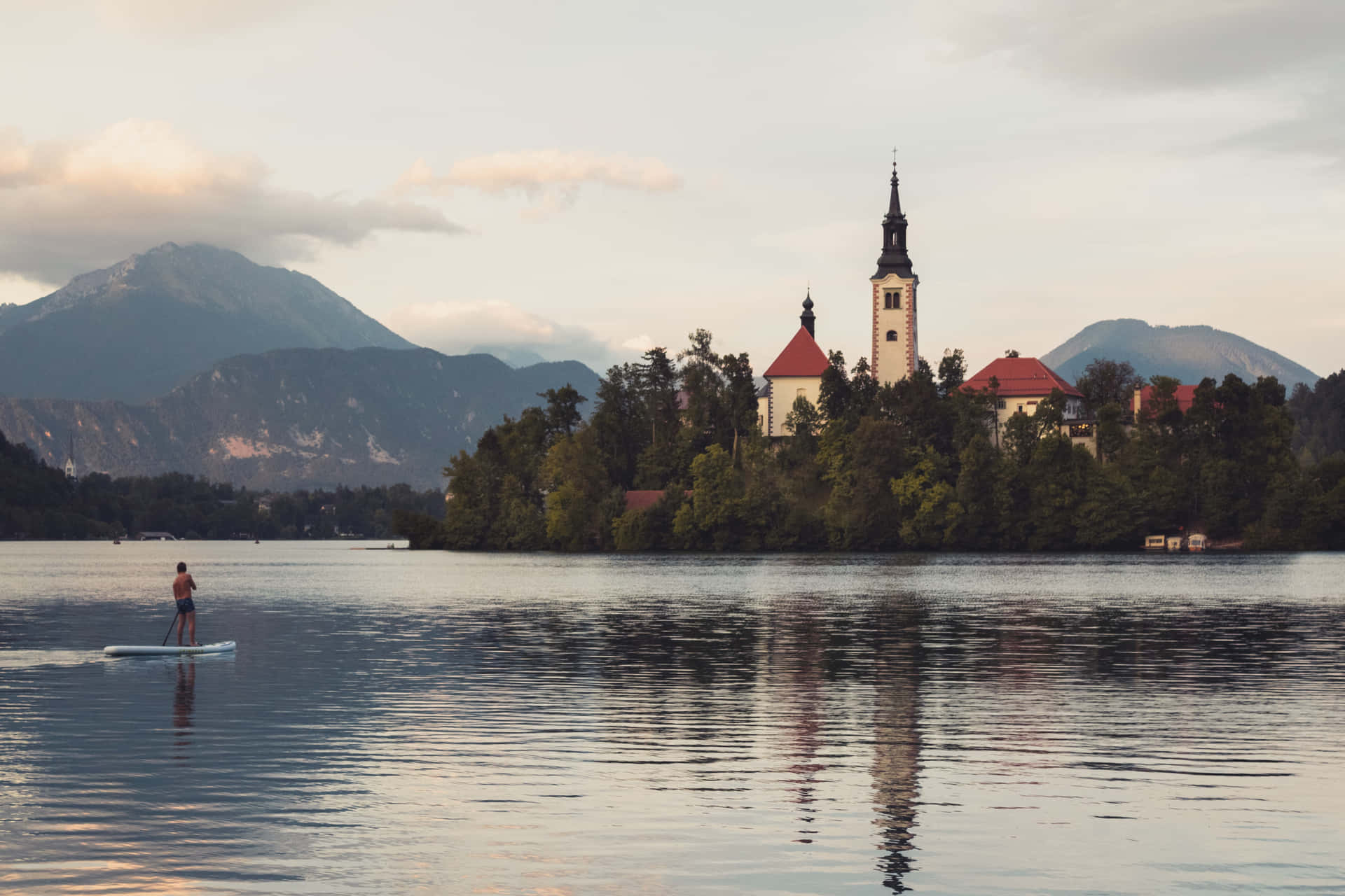 Man Paddling At Lake Bled Background