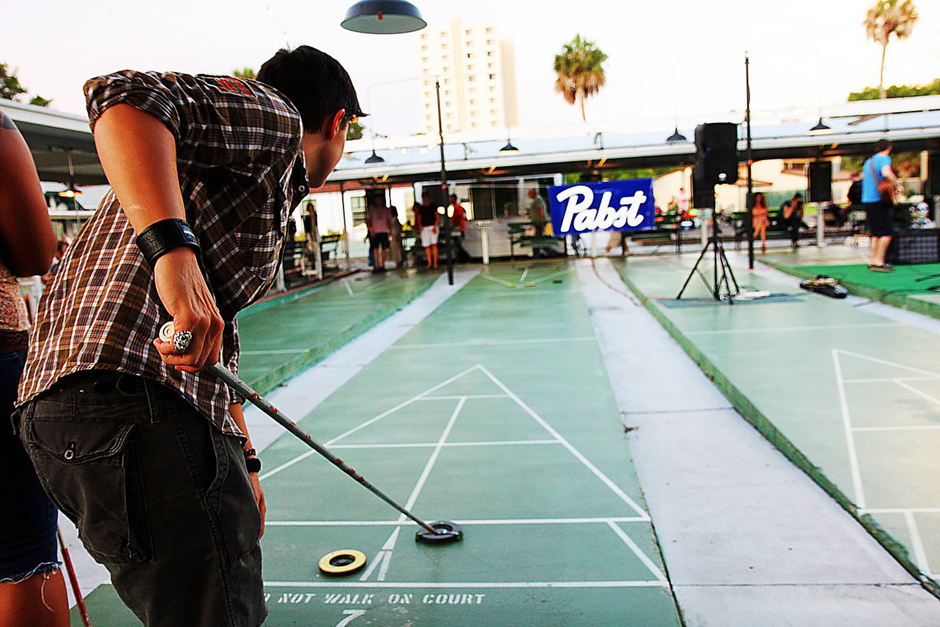 Man Playing At St. Pete Shuffleboard Club Background