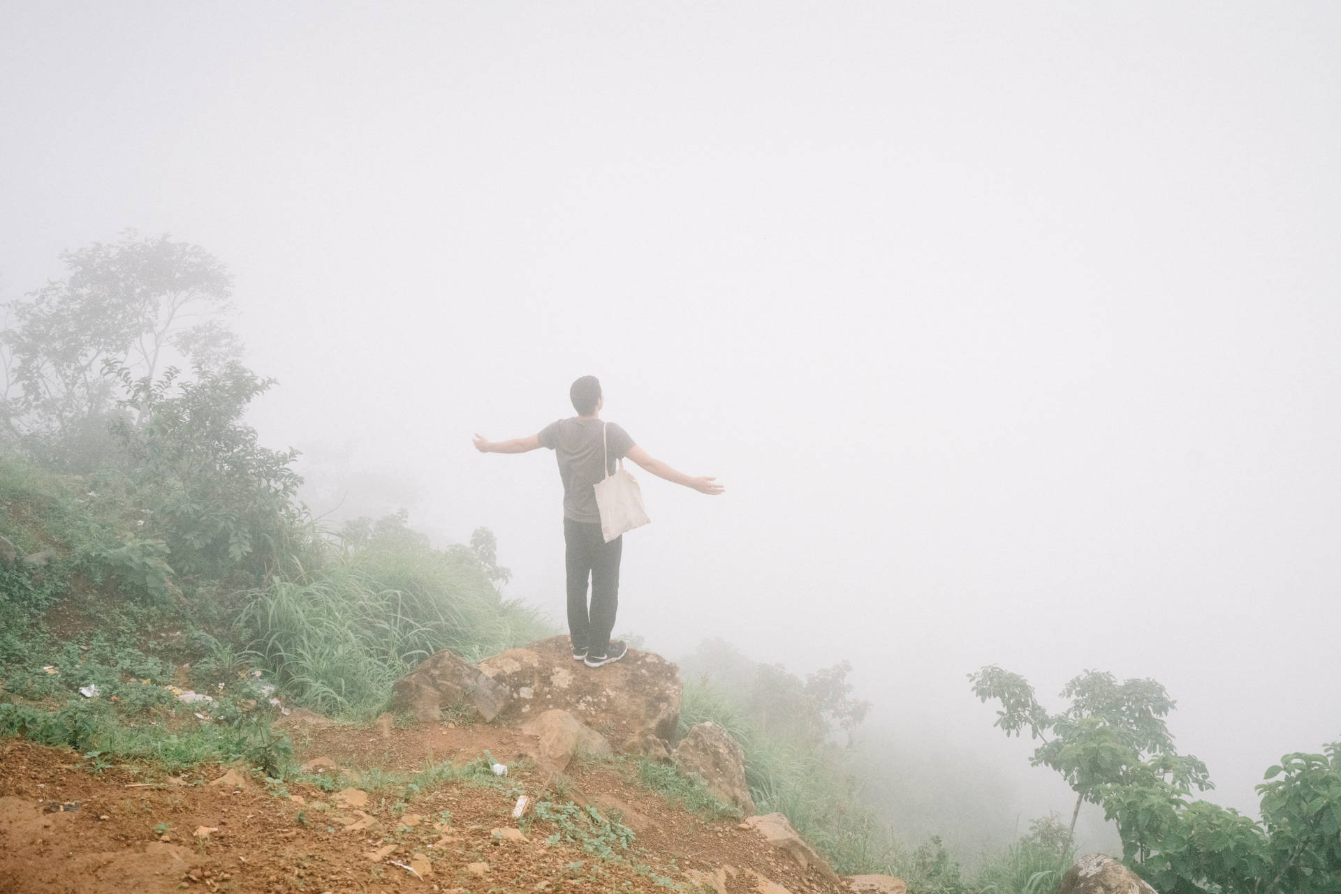 Man Posing At Cliff Edge In Sierra Leone Background