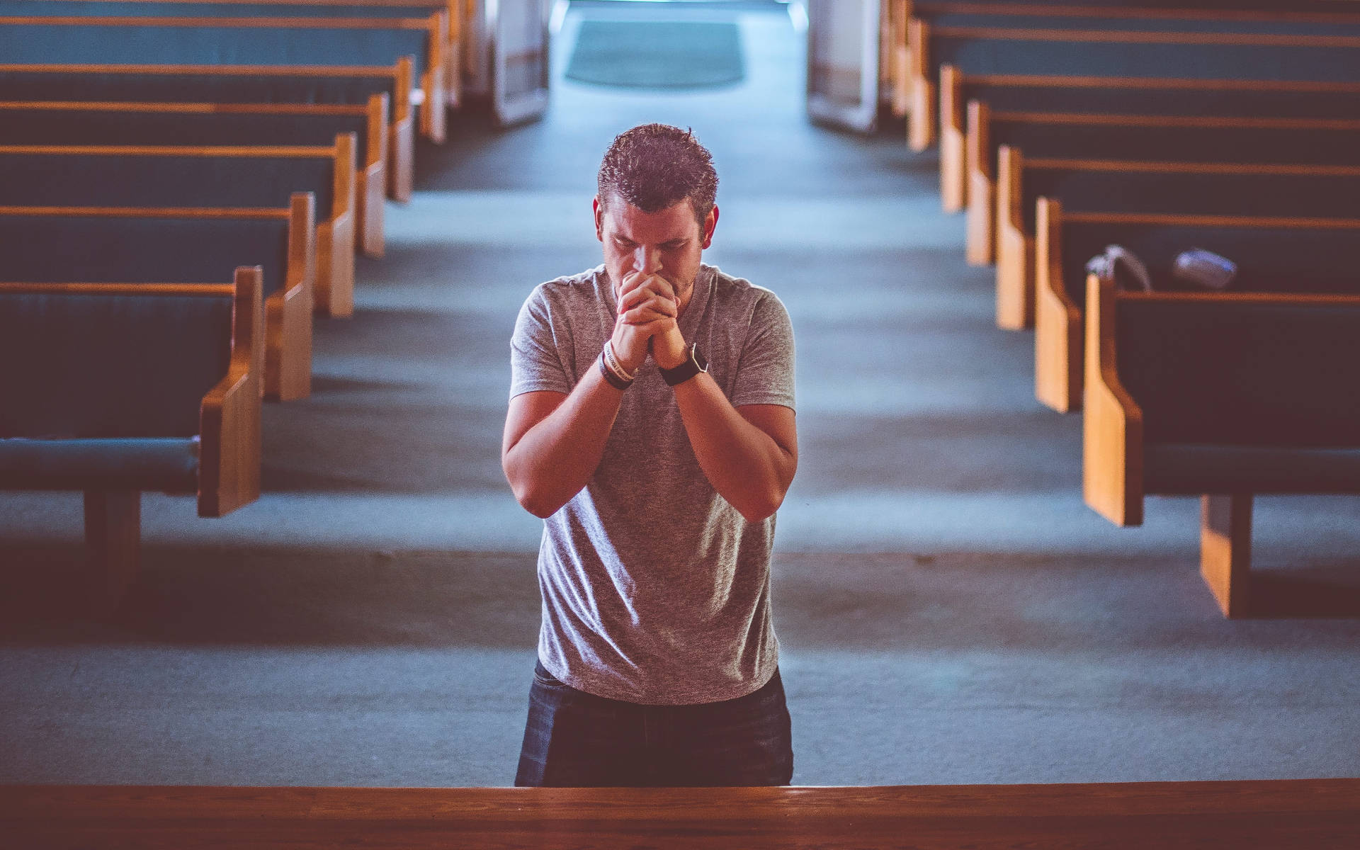 Man Praying Alone In Church