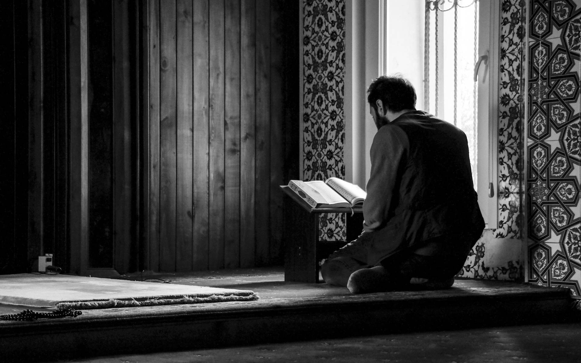 Man Reading Quran Grayscale Background