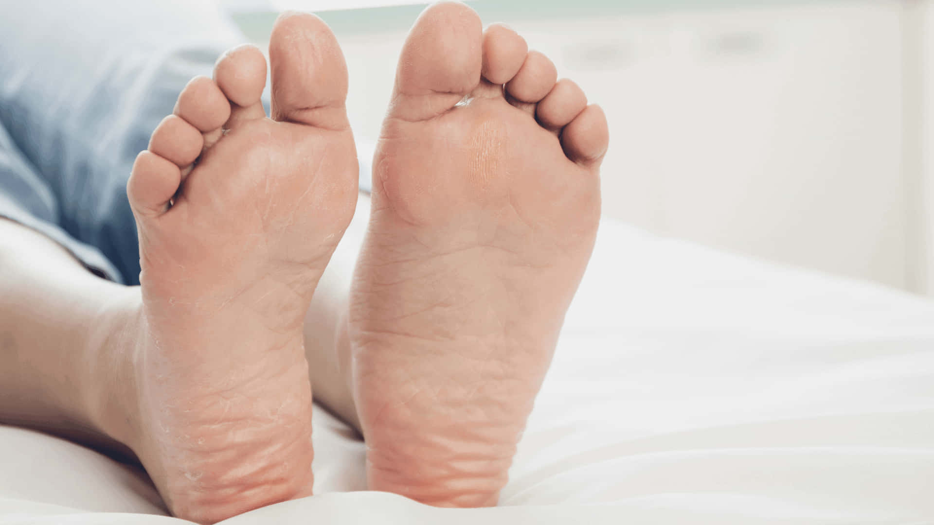 Man Relaxing On Bed - Closeup Of Male Feet