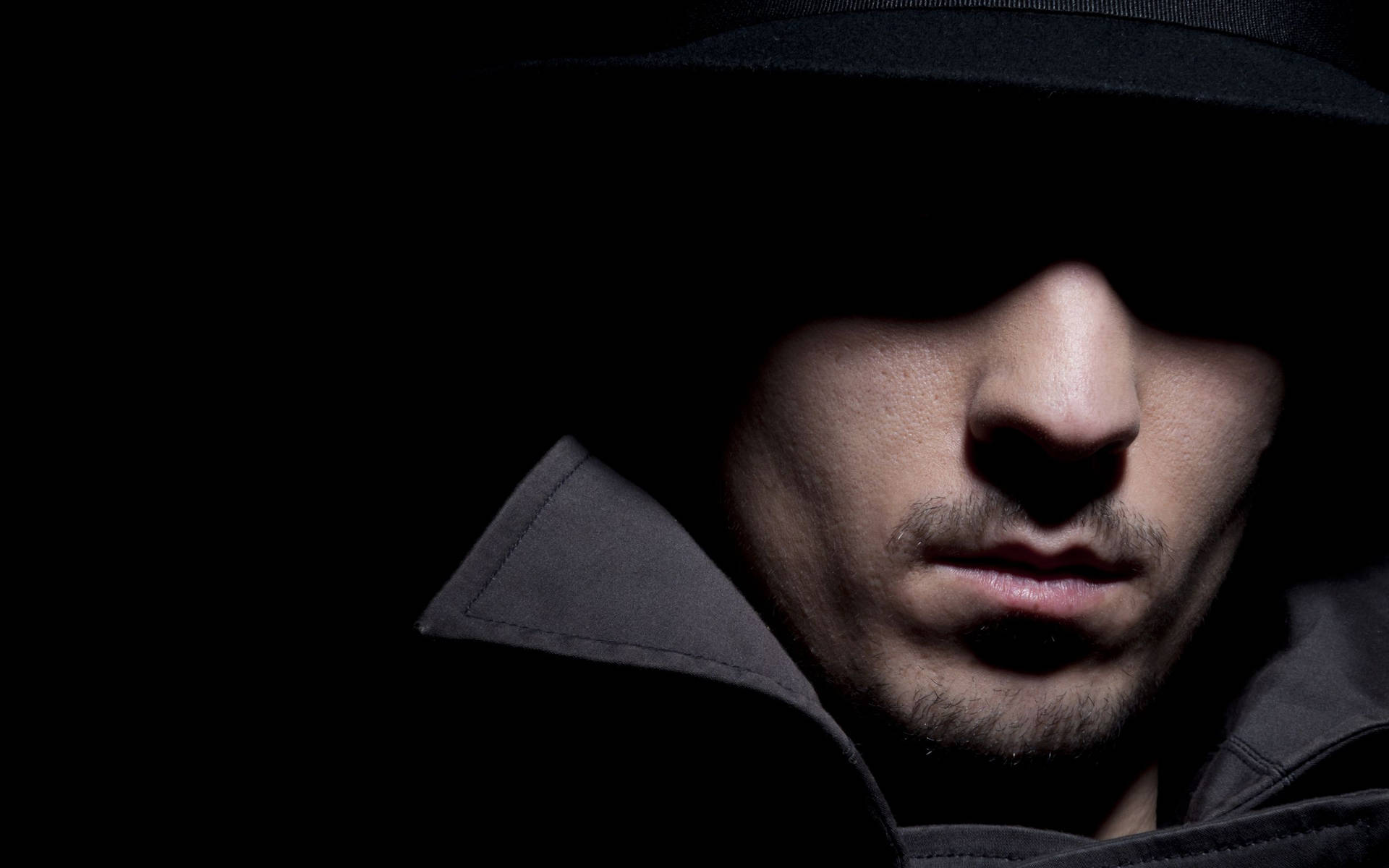 Man's Face Covered In Shadow Background
