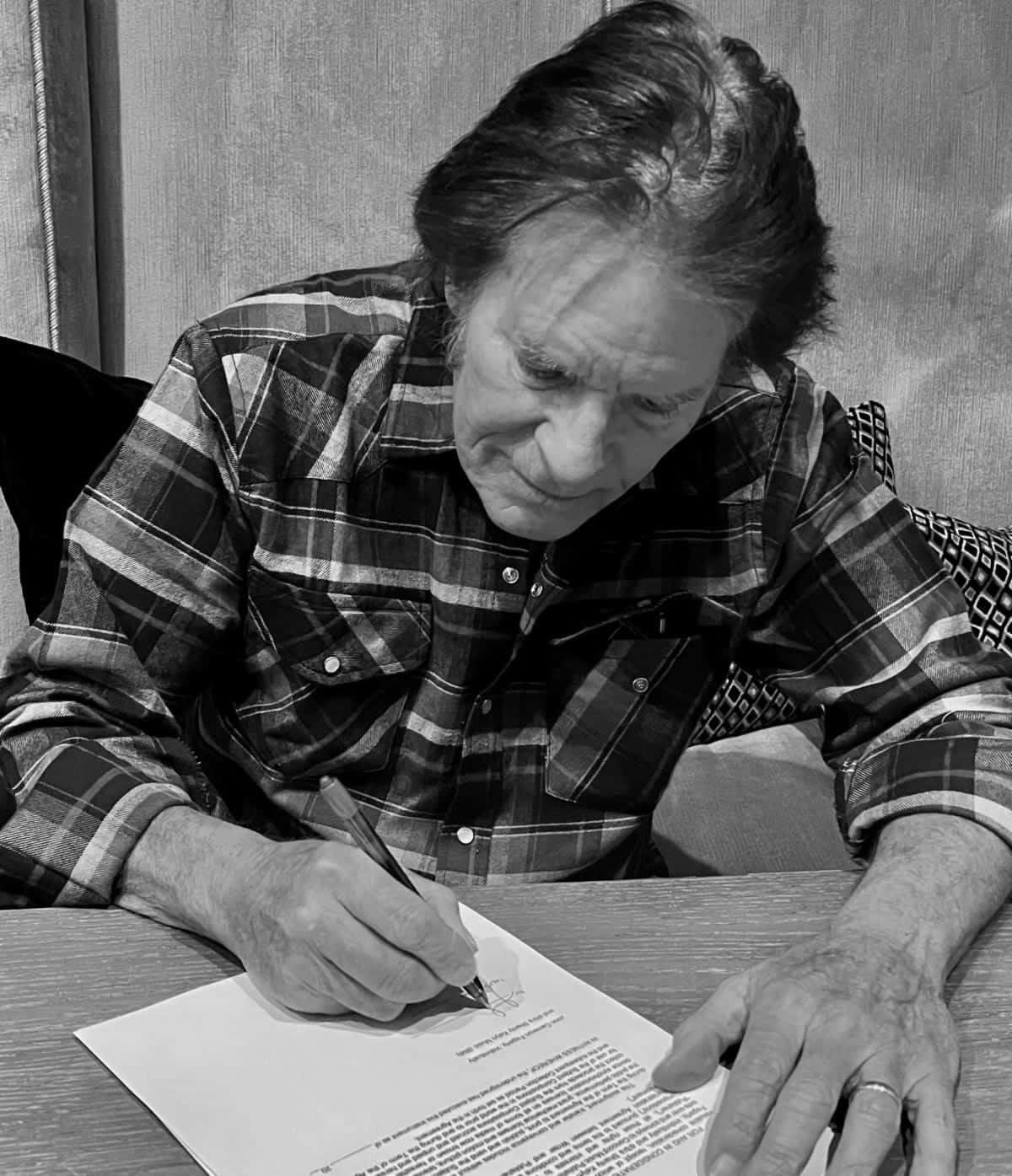 Man Signing Document Blackand White Background