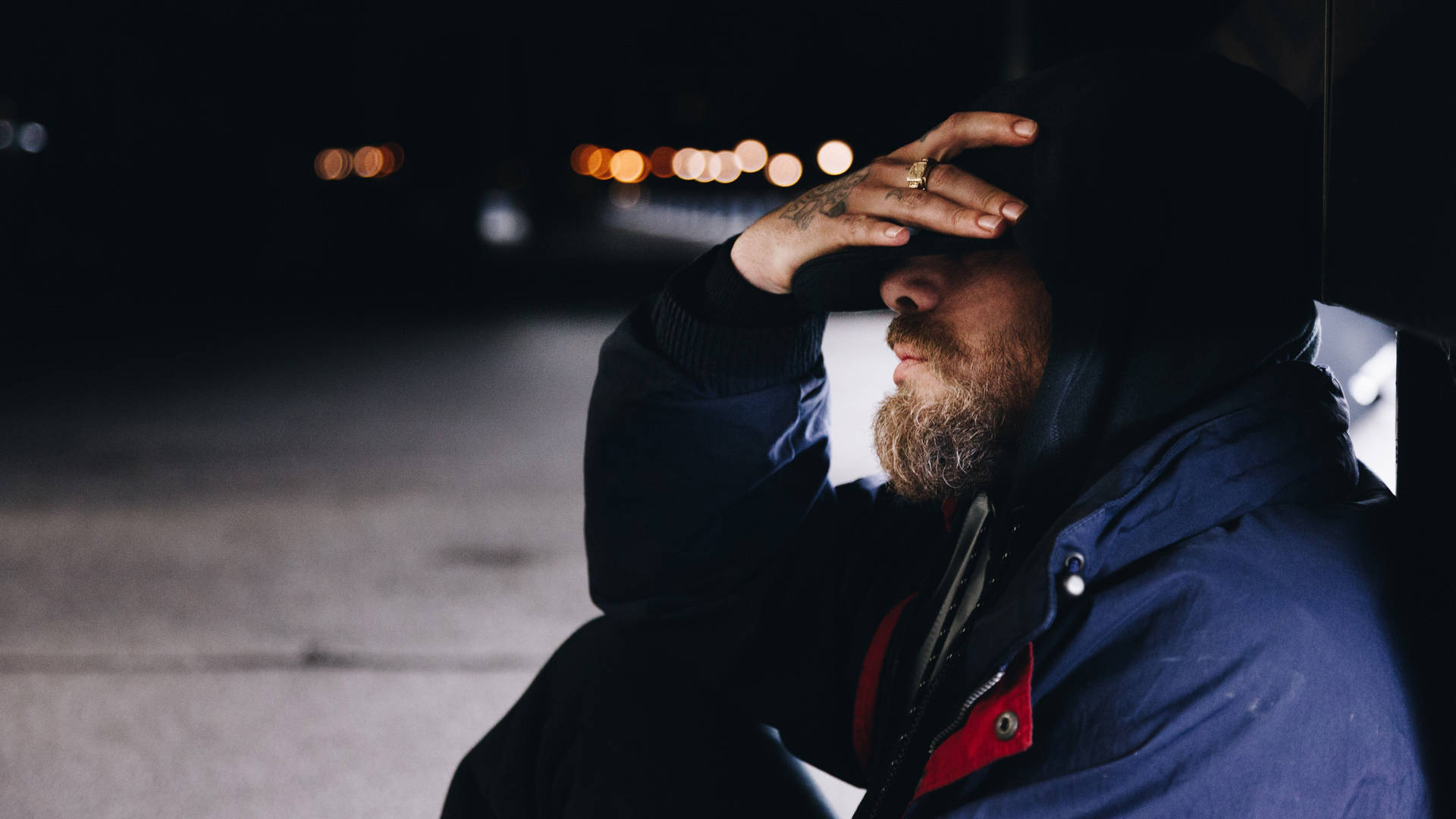 Man Sitting Alone By Bridge Railing Background