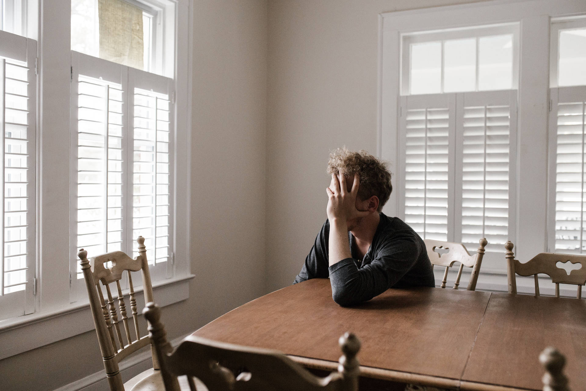 Man Sitting Alone In Dining Room Background