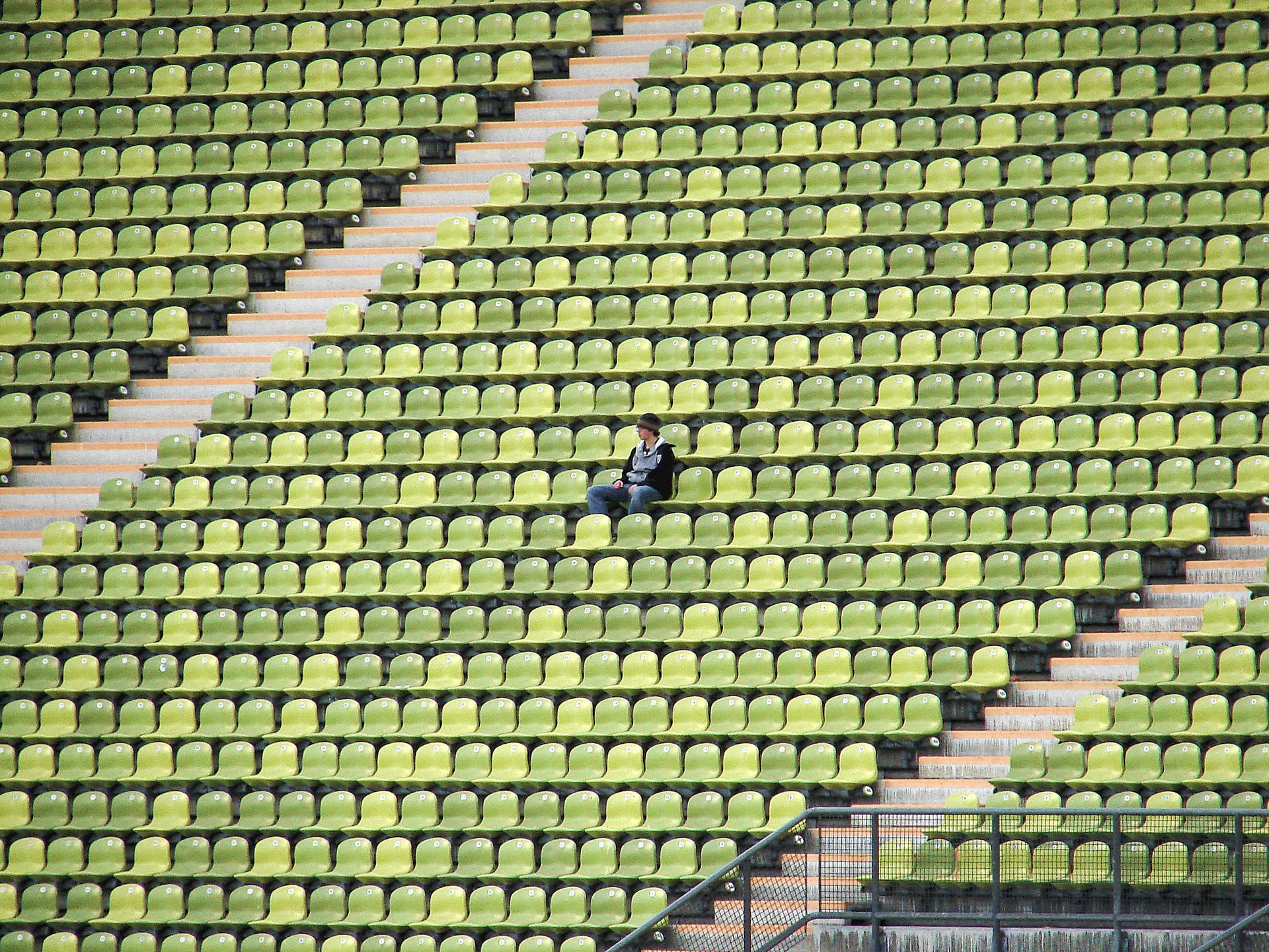 Man Sitting Alone On Stadium Seat