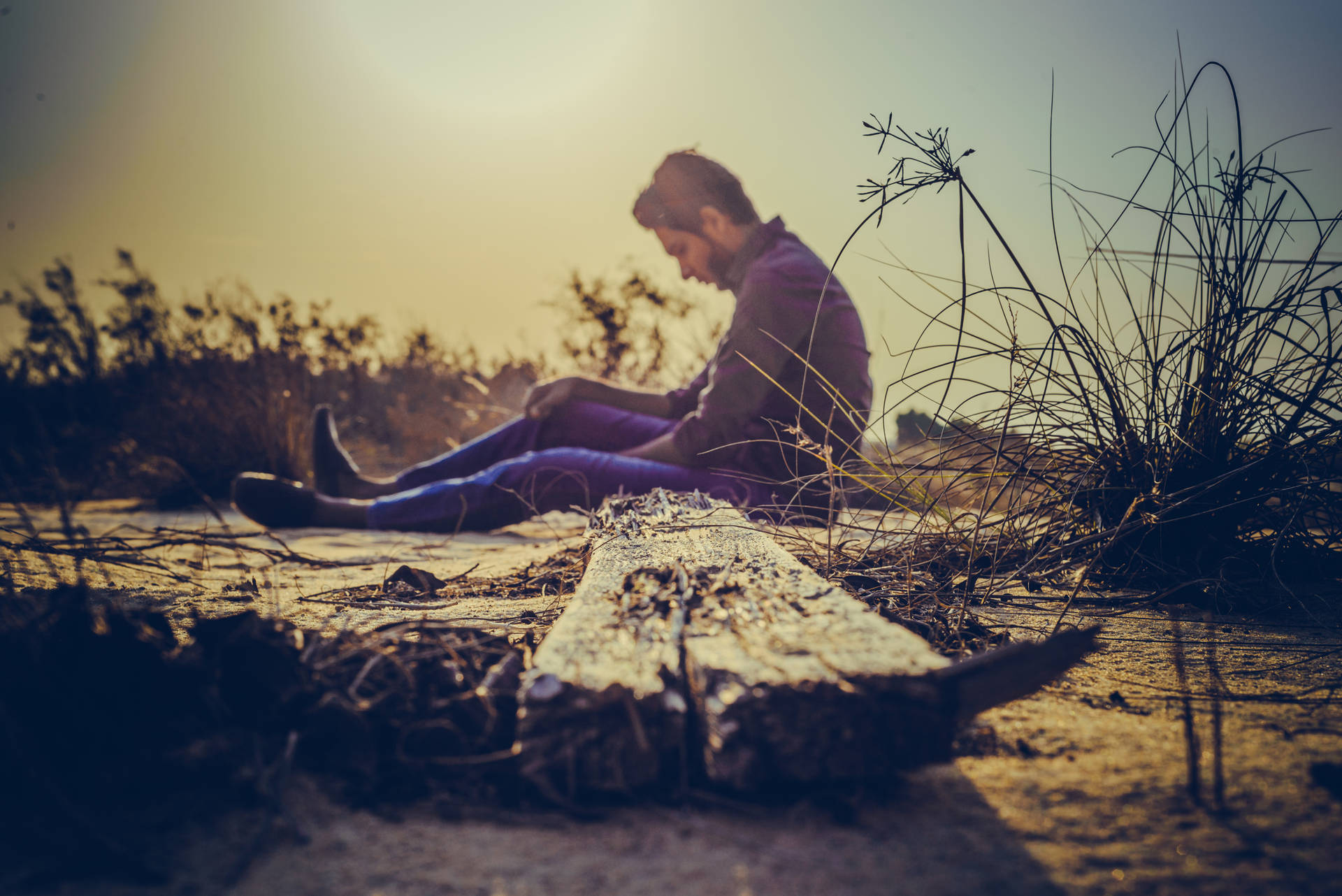 Man Sitting Alone On The Ground