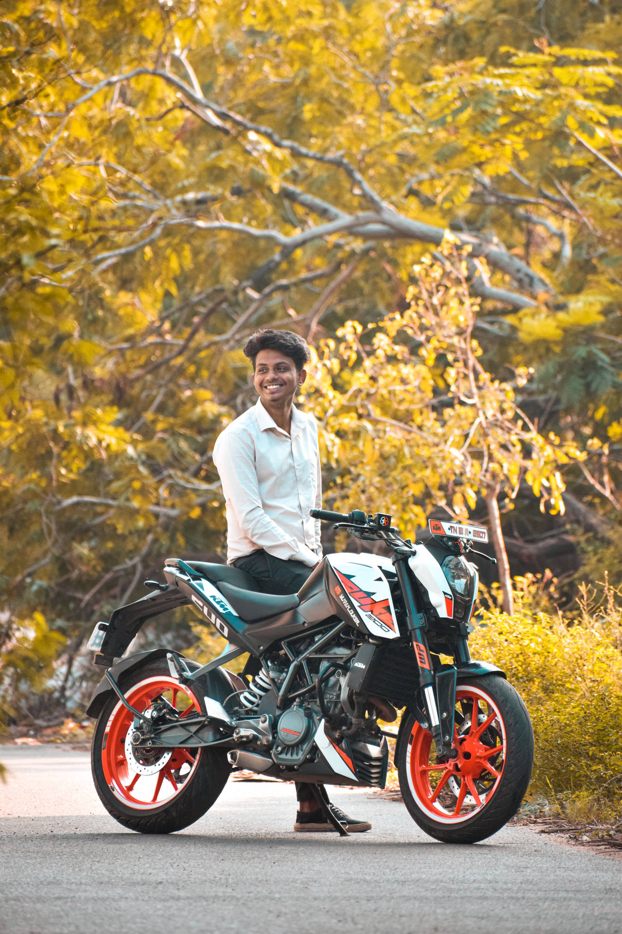 Man Sitting On A Ktm Duke 200