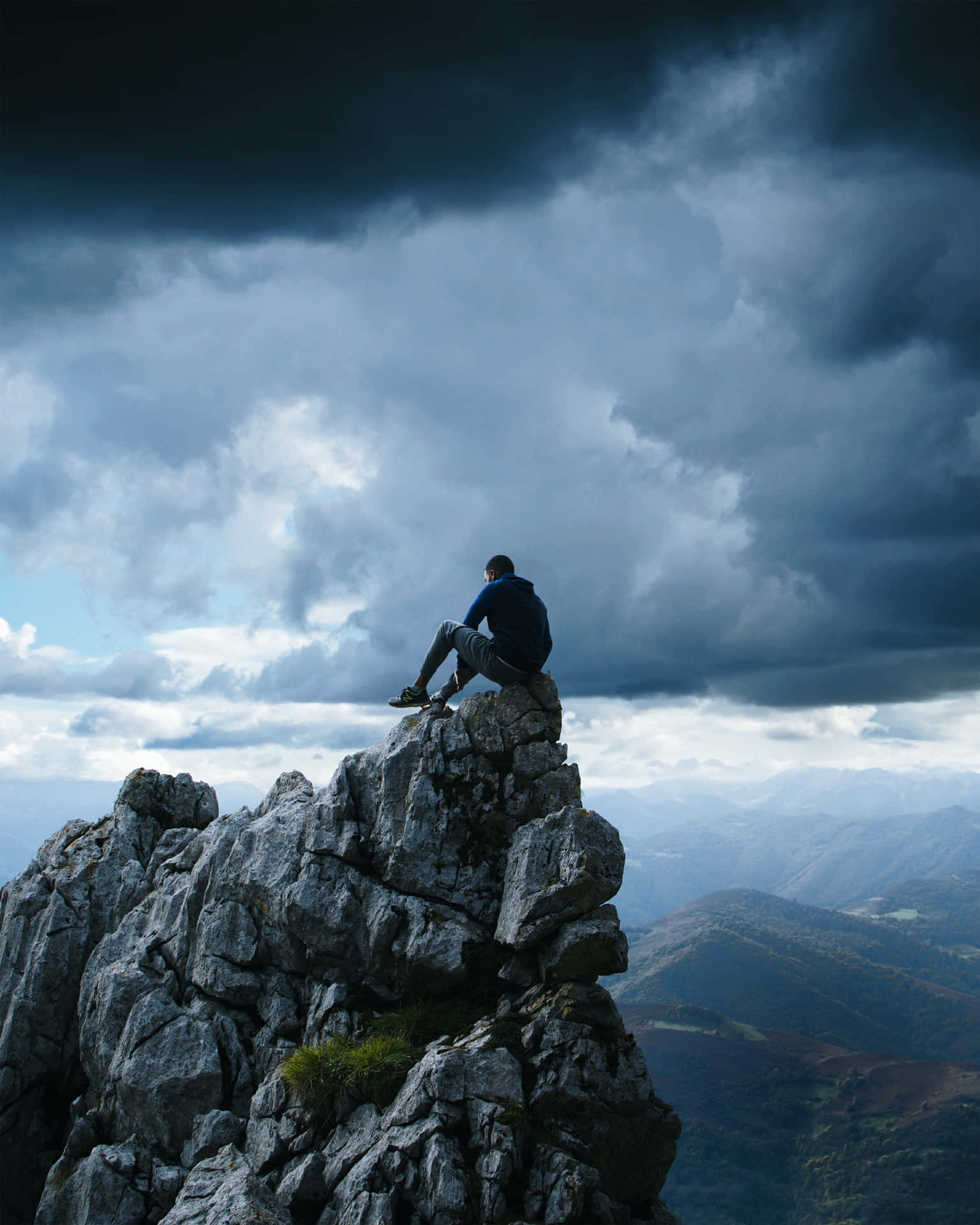 Man Sitting On Cliff Point Precipice