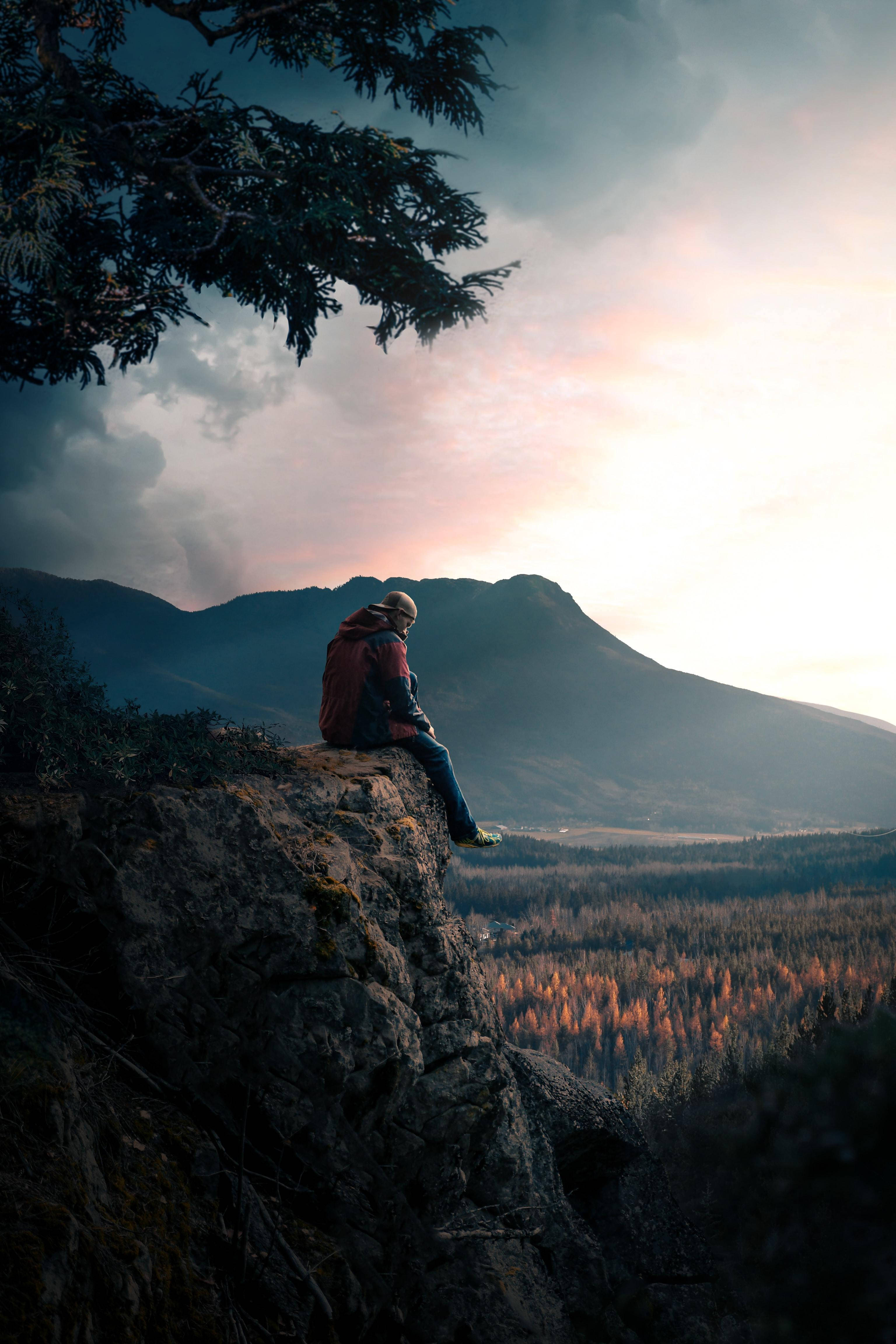 Man Sitting On Rock Alone Phone