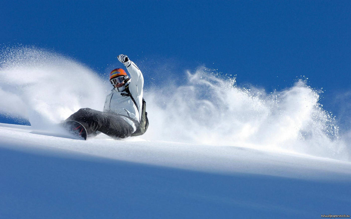 Man Sliding Through Snow With A Snowboard