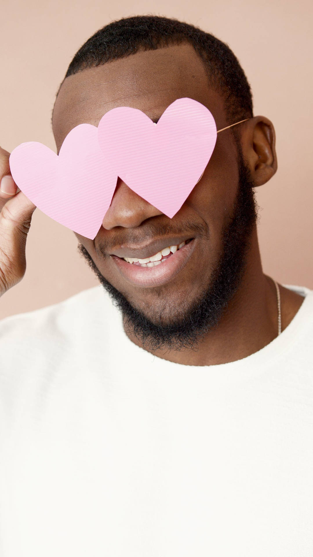 Man Smiling With Pastel Pink Heart Background
