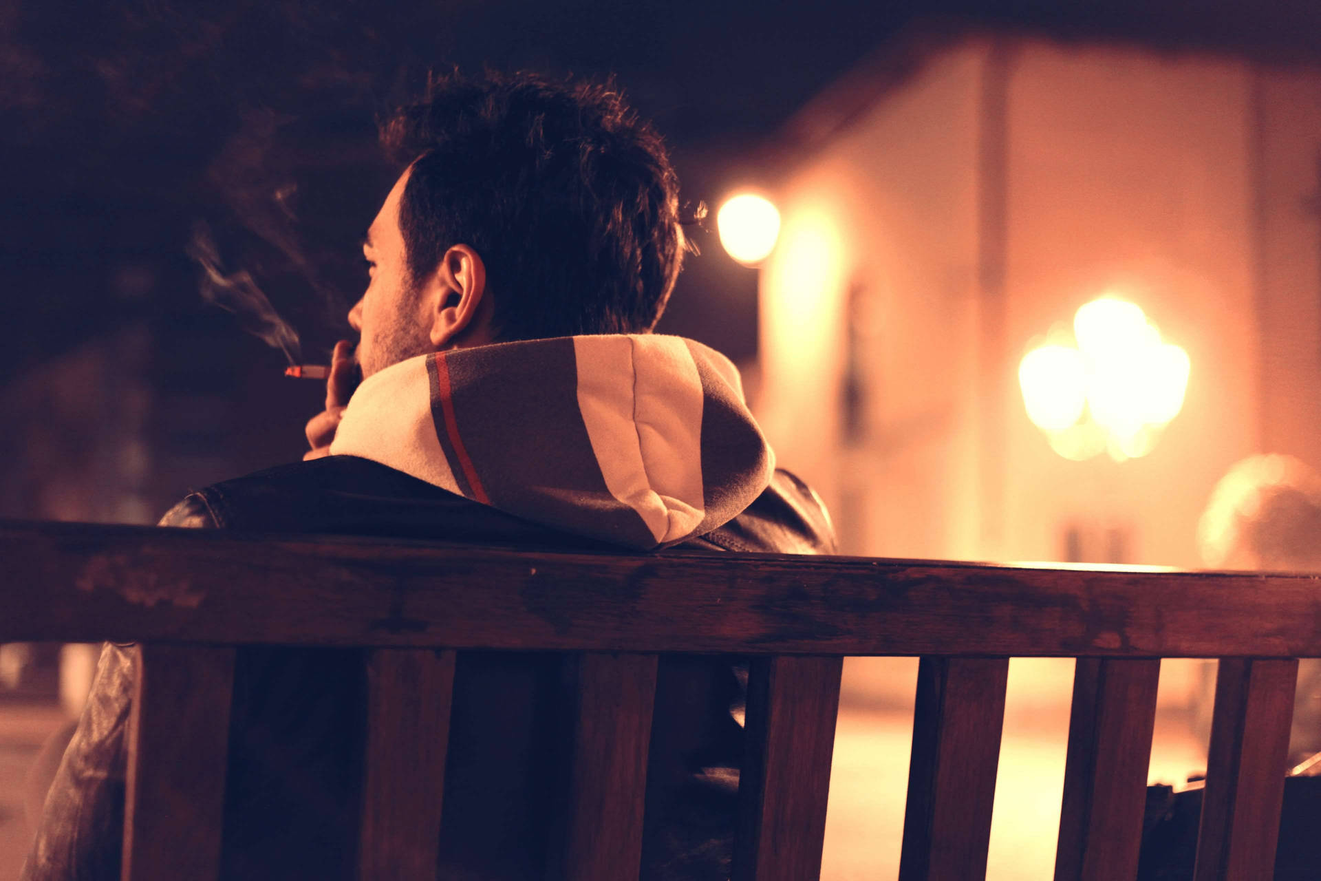 Man Smoking While Sitting Alone Background