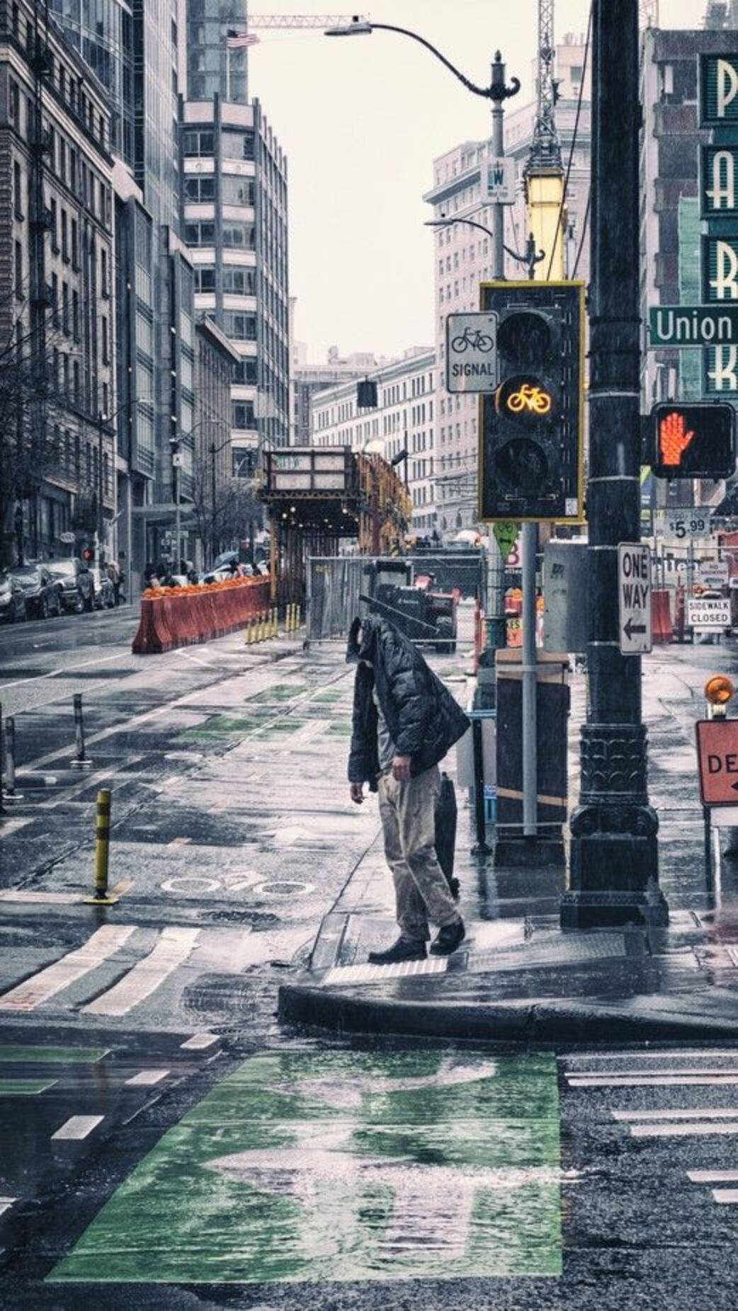 Man Soaked In Seattle Rain Background