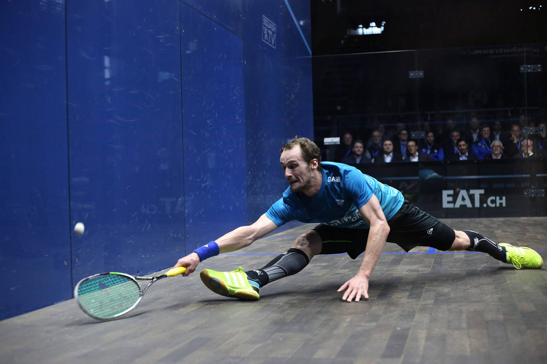 Man Splits While Playing Squash Background