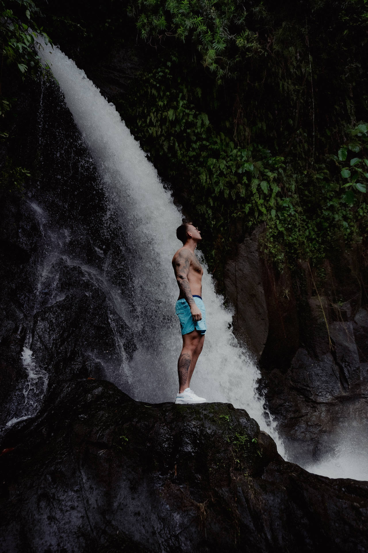 Man Standing By The Falling Water