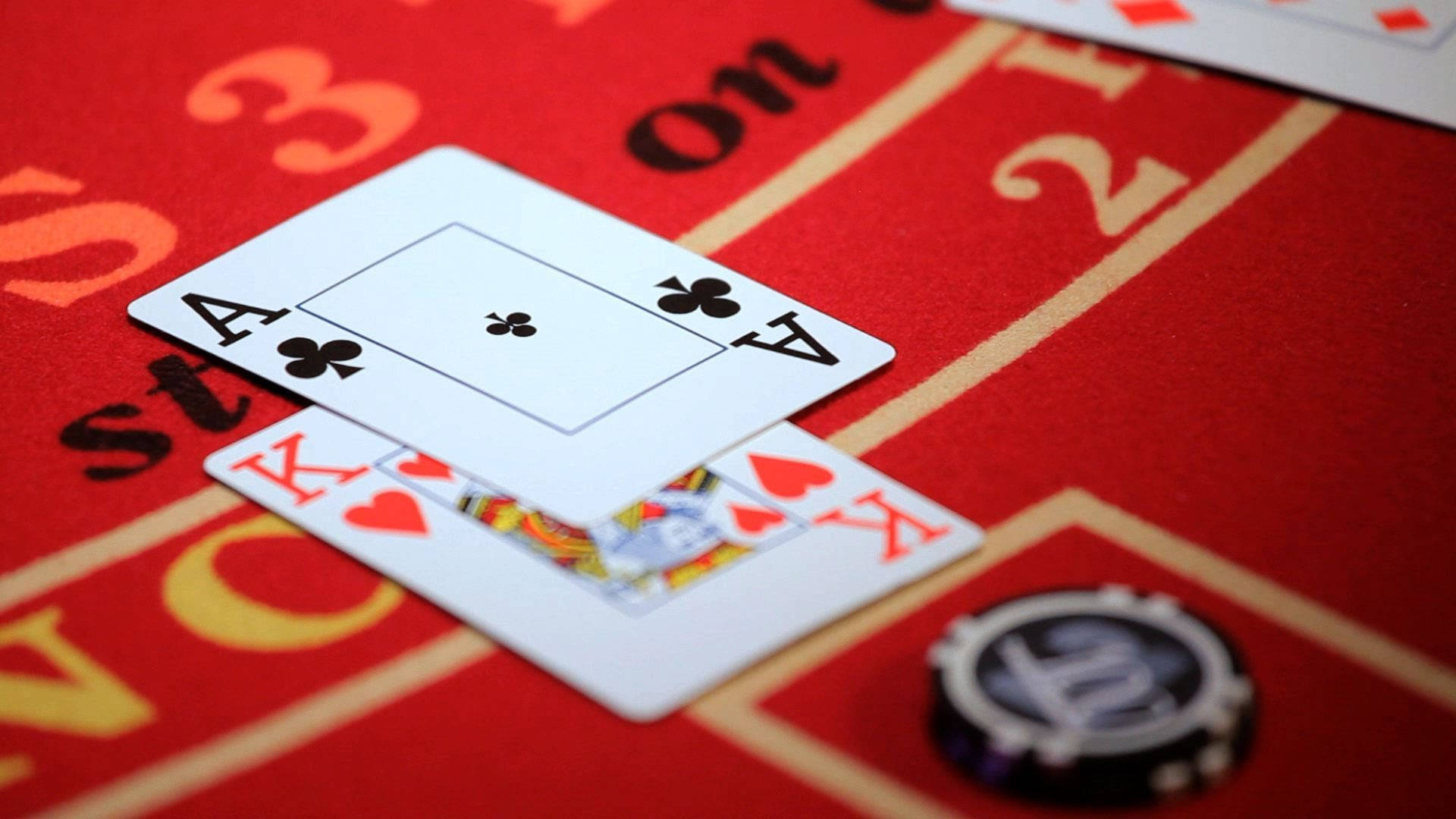 Man Strategizing Over A Game Of Blackjack Background