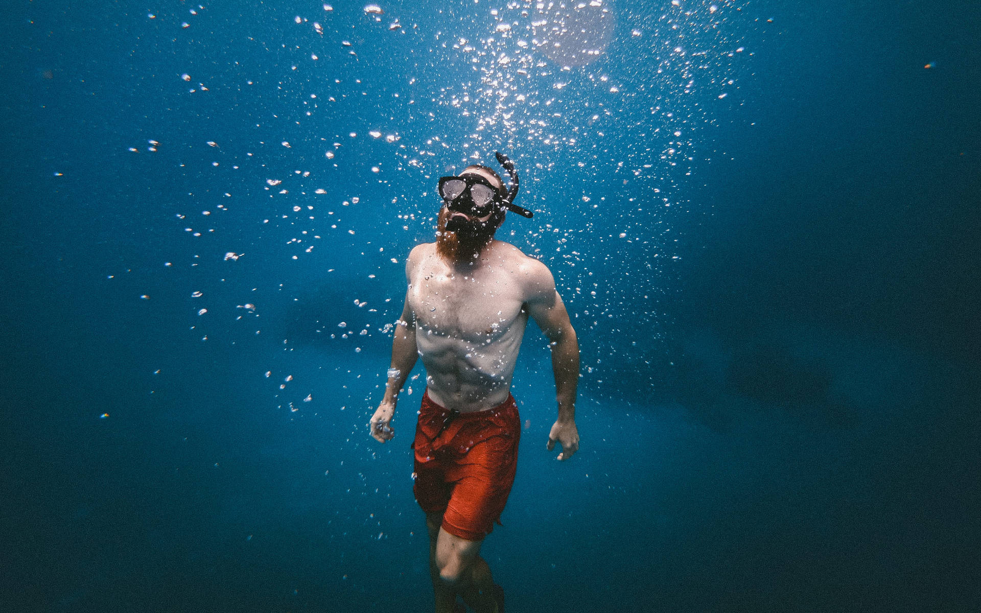 Man Swimming Upward Under Ocean Background