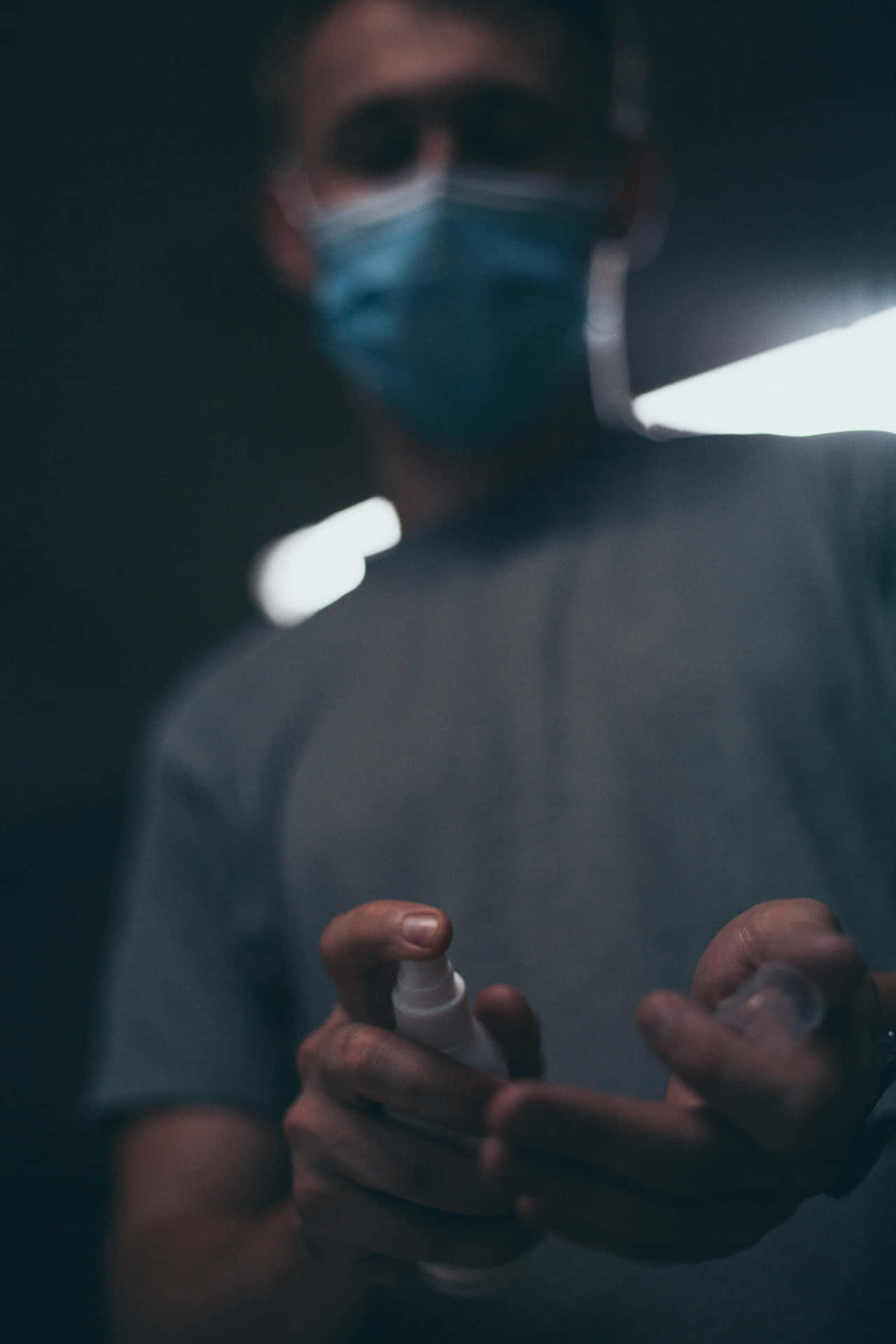 Man Using Antiseptic Hand Spray Background