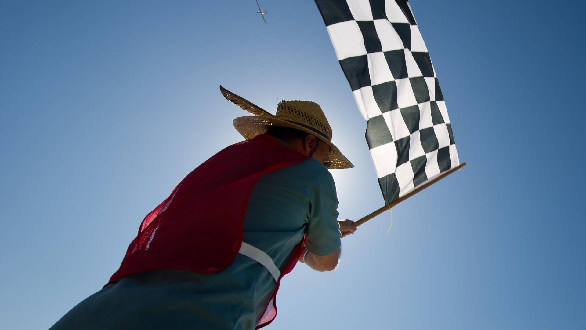 Man Waving A Checkered Flag Background