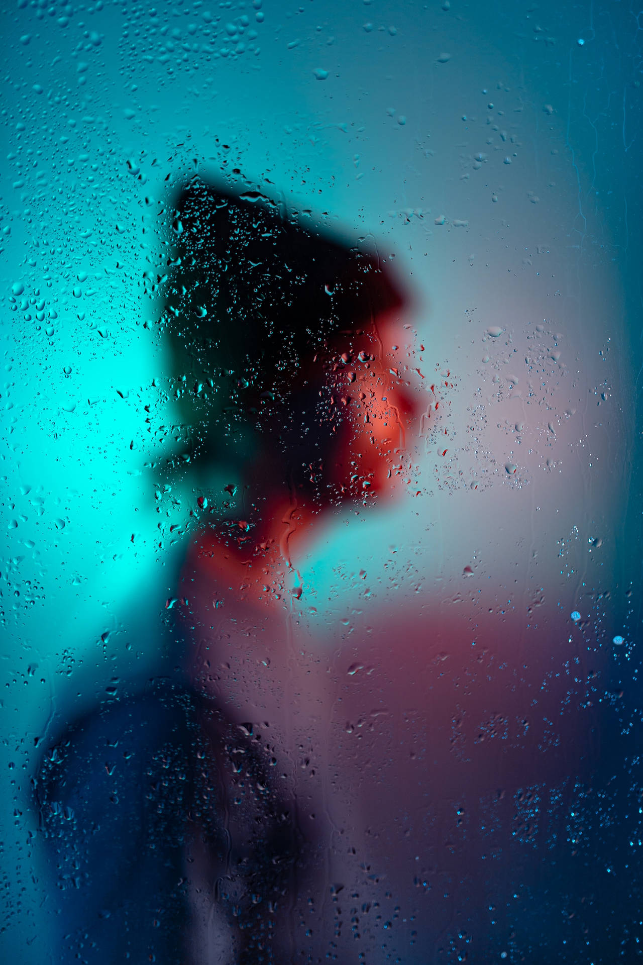 Man With A Bonnet On Behind A Misty Glass Profile Background