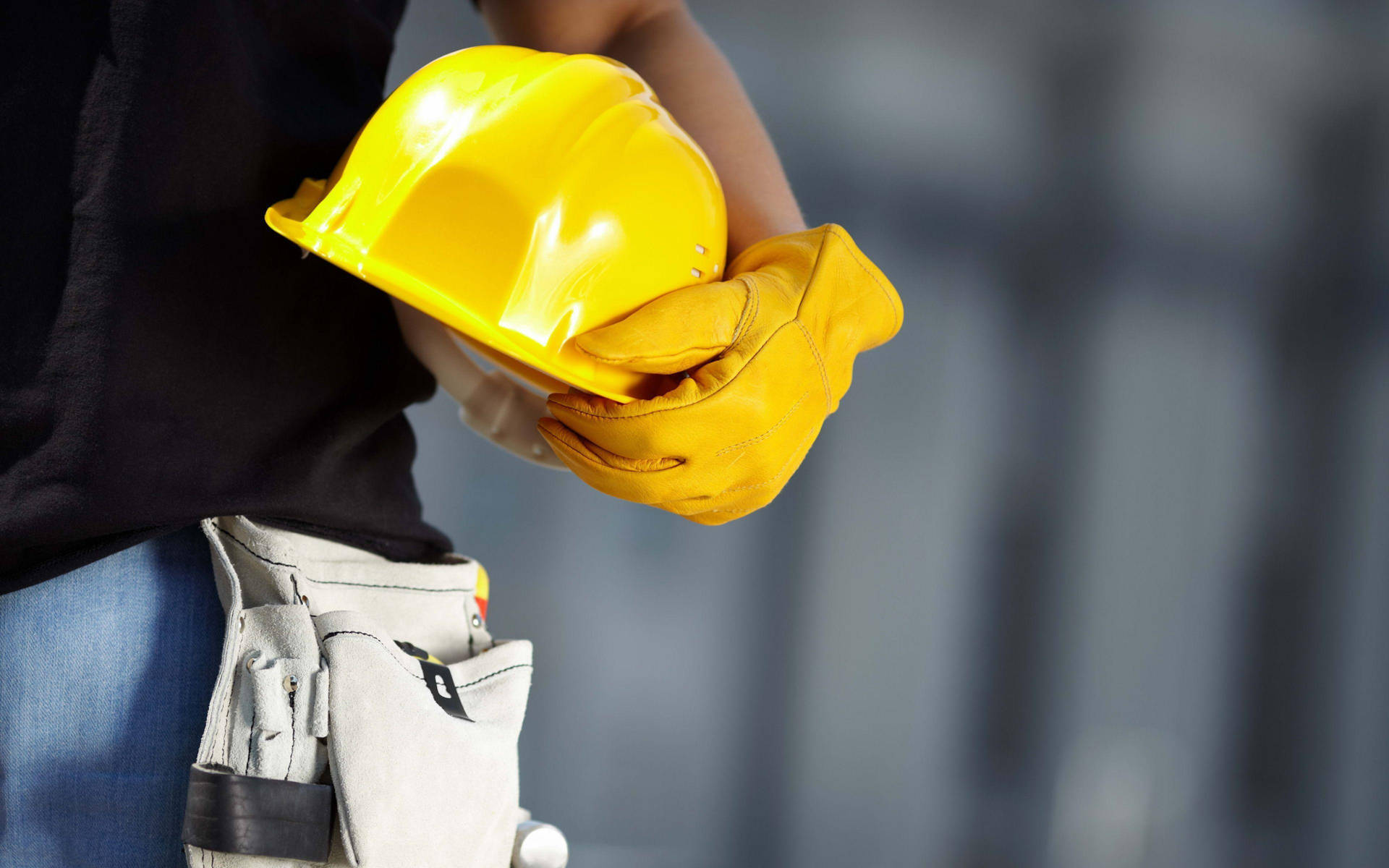 Man With A Glove Carrying Construction Hard Hat