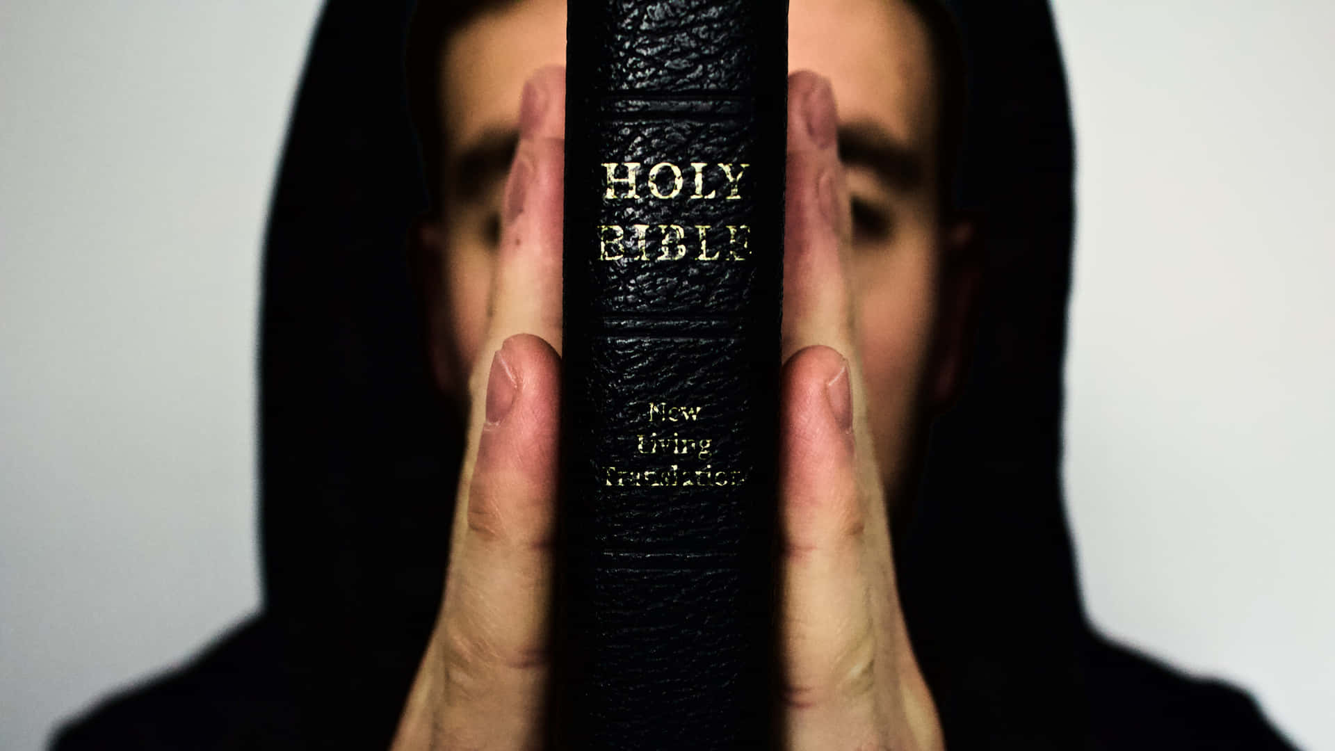 Man With Black Holy Bible Background