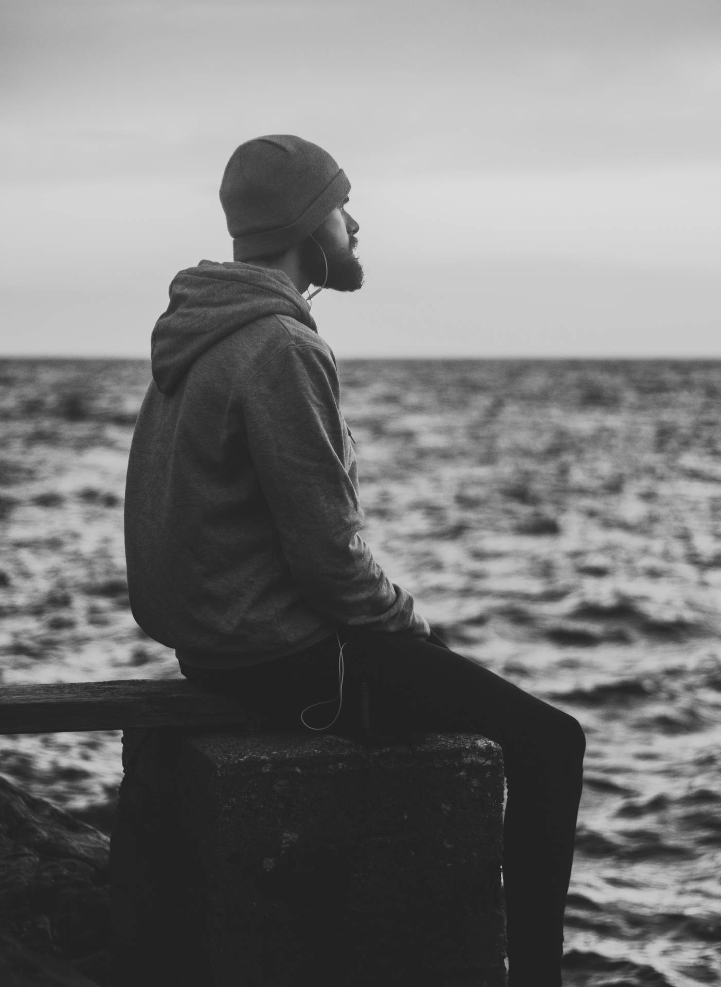 Man With Earphones Sitting Alone Background