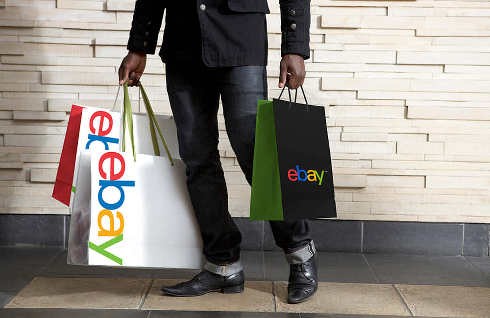 Man With Ebay Uk Logo On Bags Background