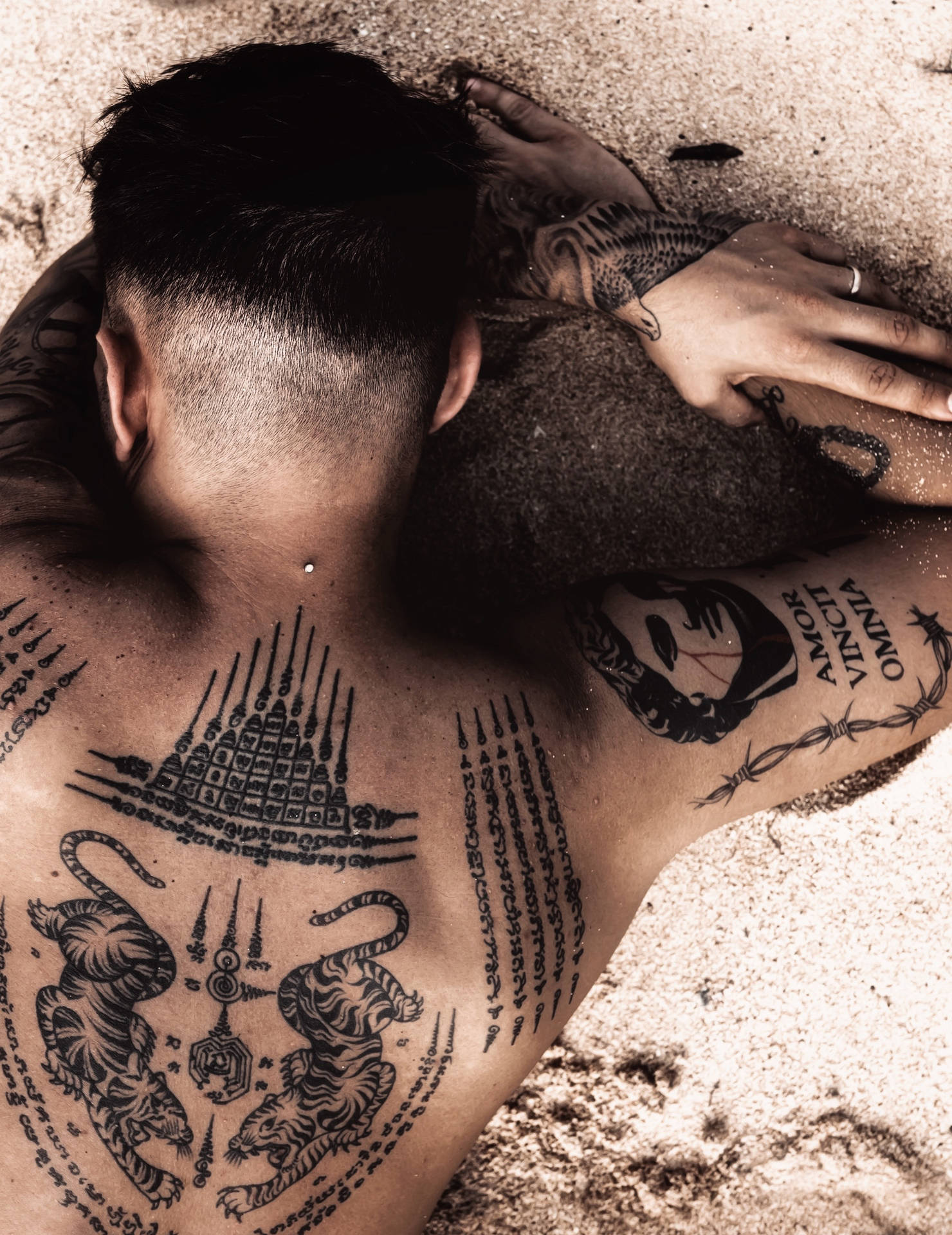 Man With Hd Tattoo On Sand