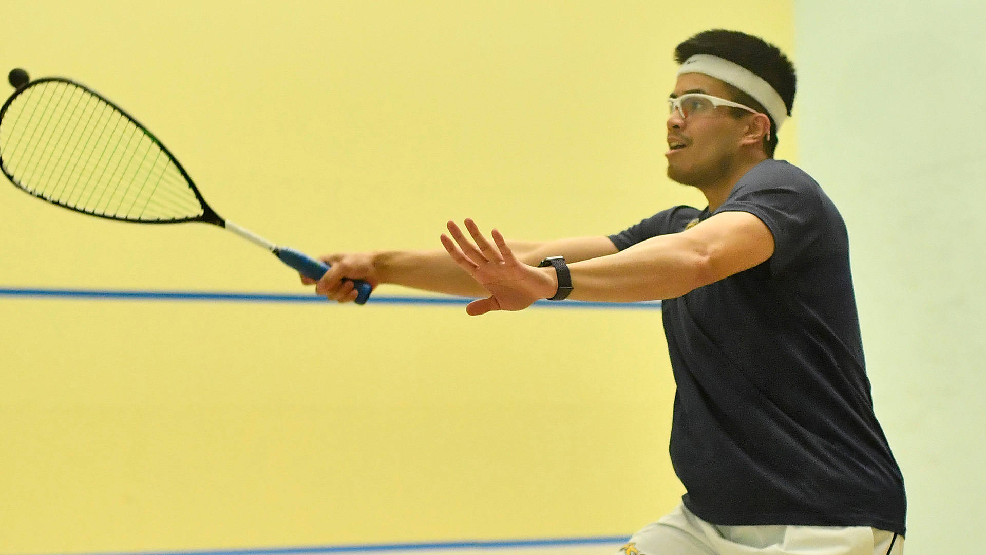 Man With Headband Playing Squash Background