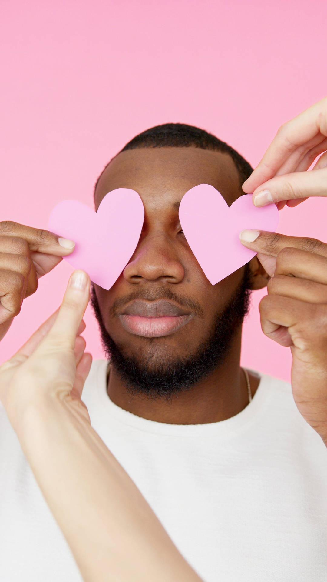 Man With Pastel Pink Heart Cutouts Background