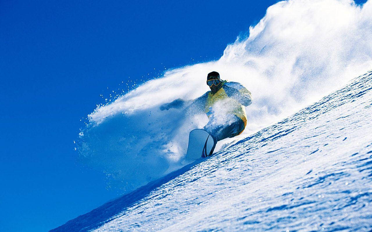 Man With Snowboard And Clouds Of Snow Background