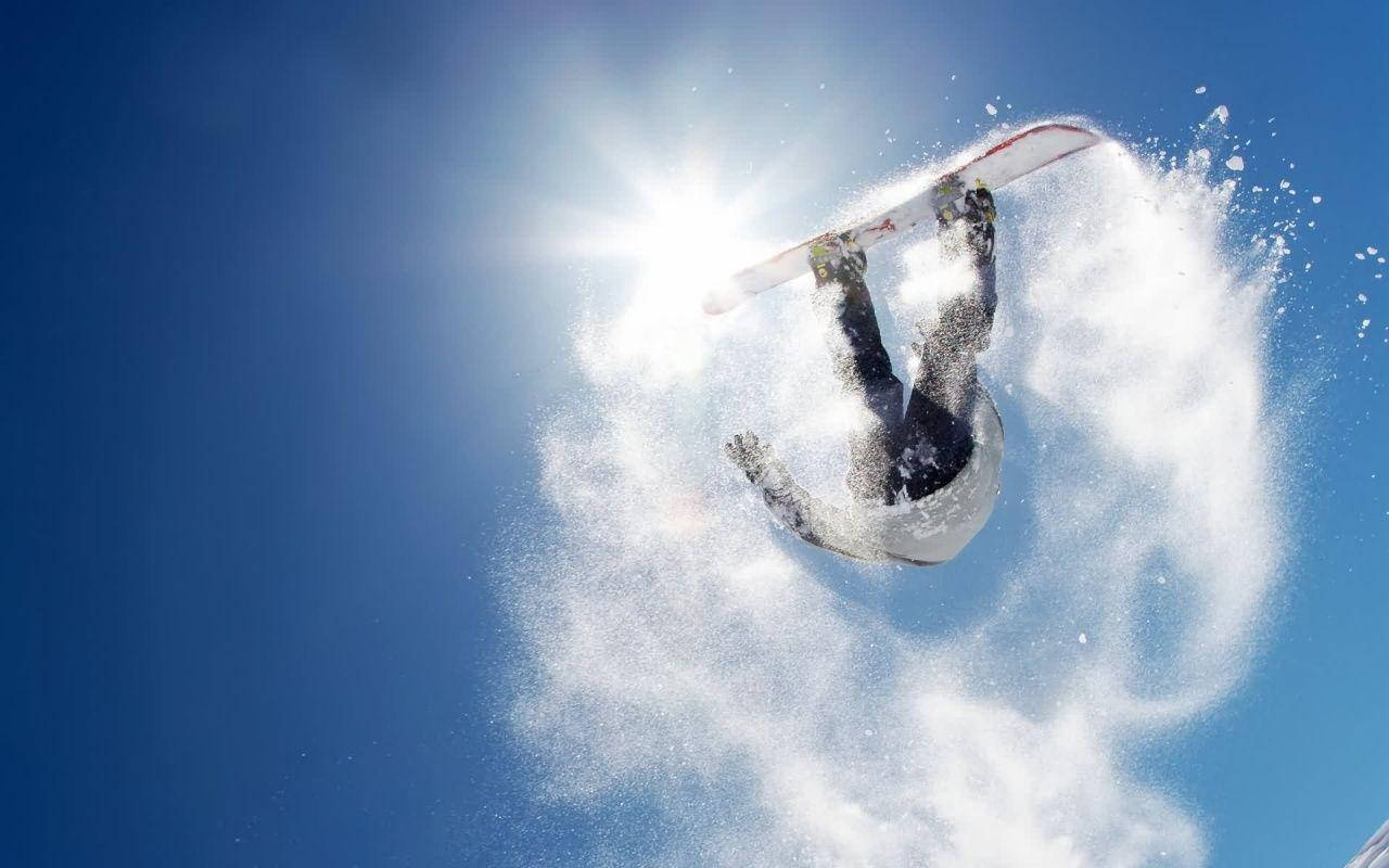 Man With Snowboard Performing A Trick