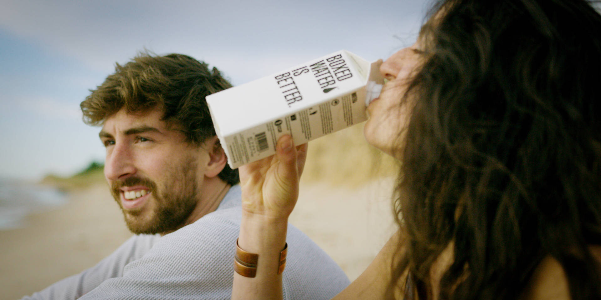 Man With Woman Drinking Water From Box