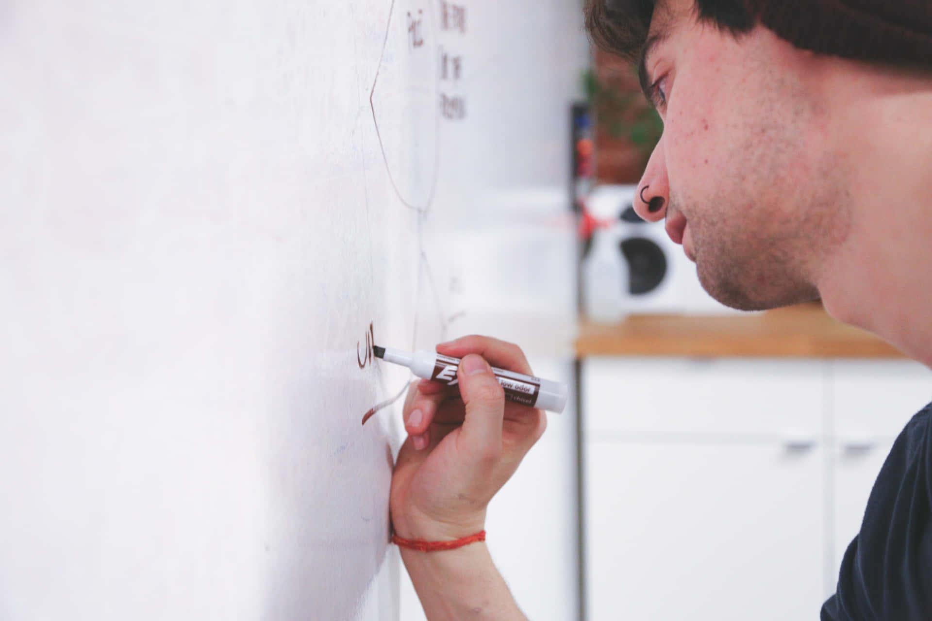 Man Writing On Whiteboard Using Permanent Marker Background