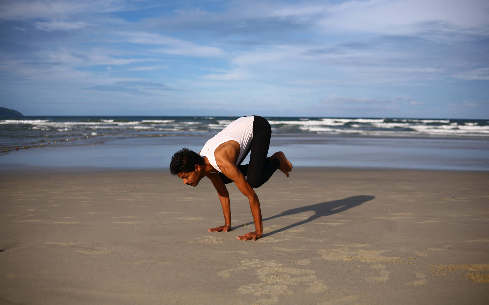 Man Yoga In Beach Shore Background