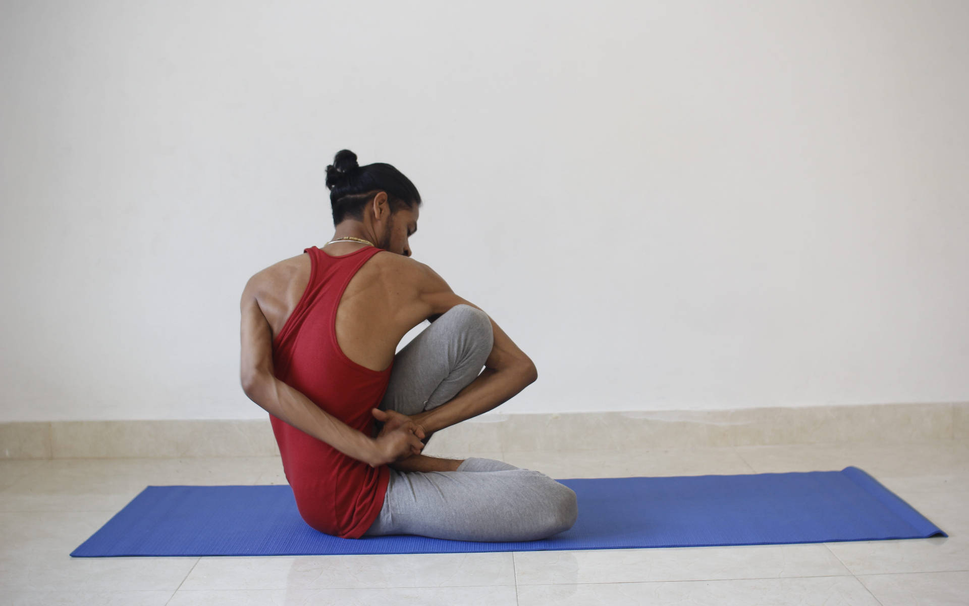 Man Yoga In Blue Mat Background