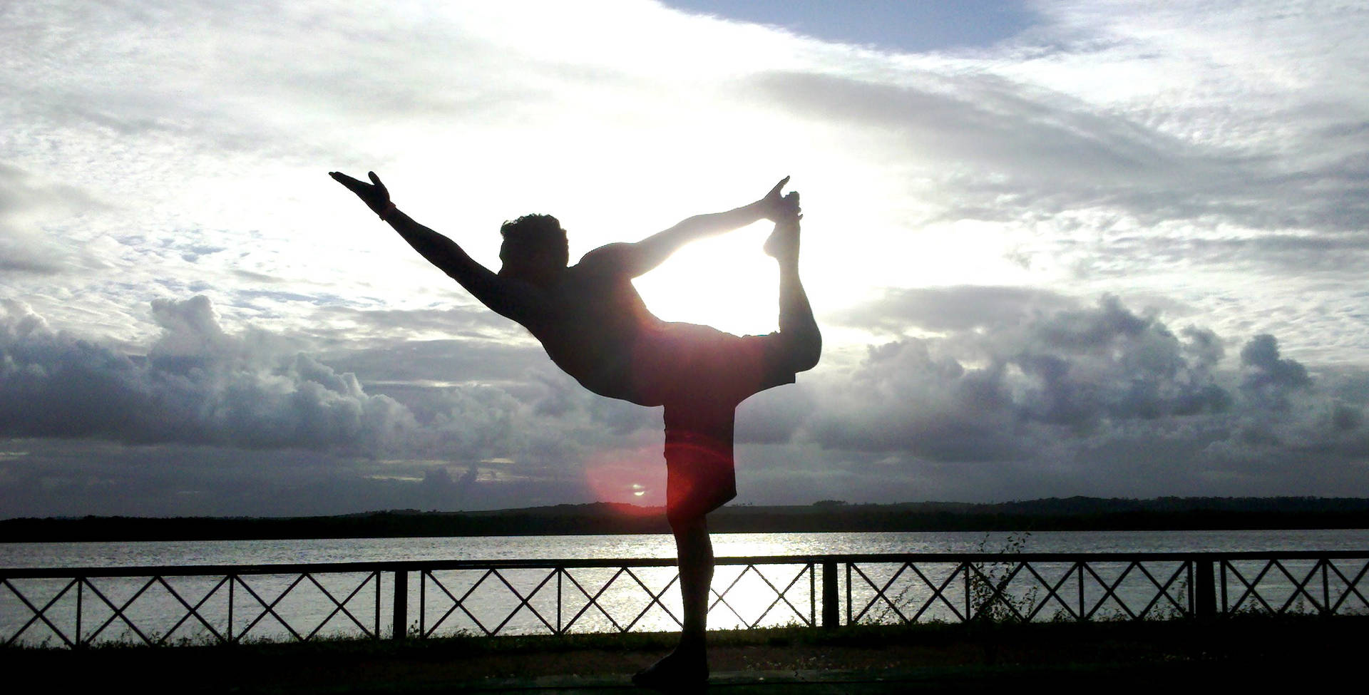 Man Yoga Stance Against Sunlight Background