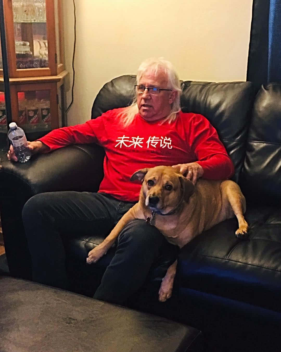 Manand Dog Relaxingon Couch