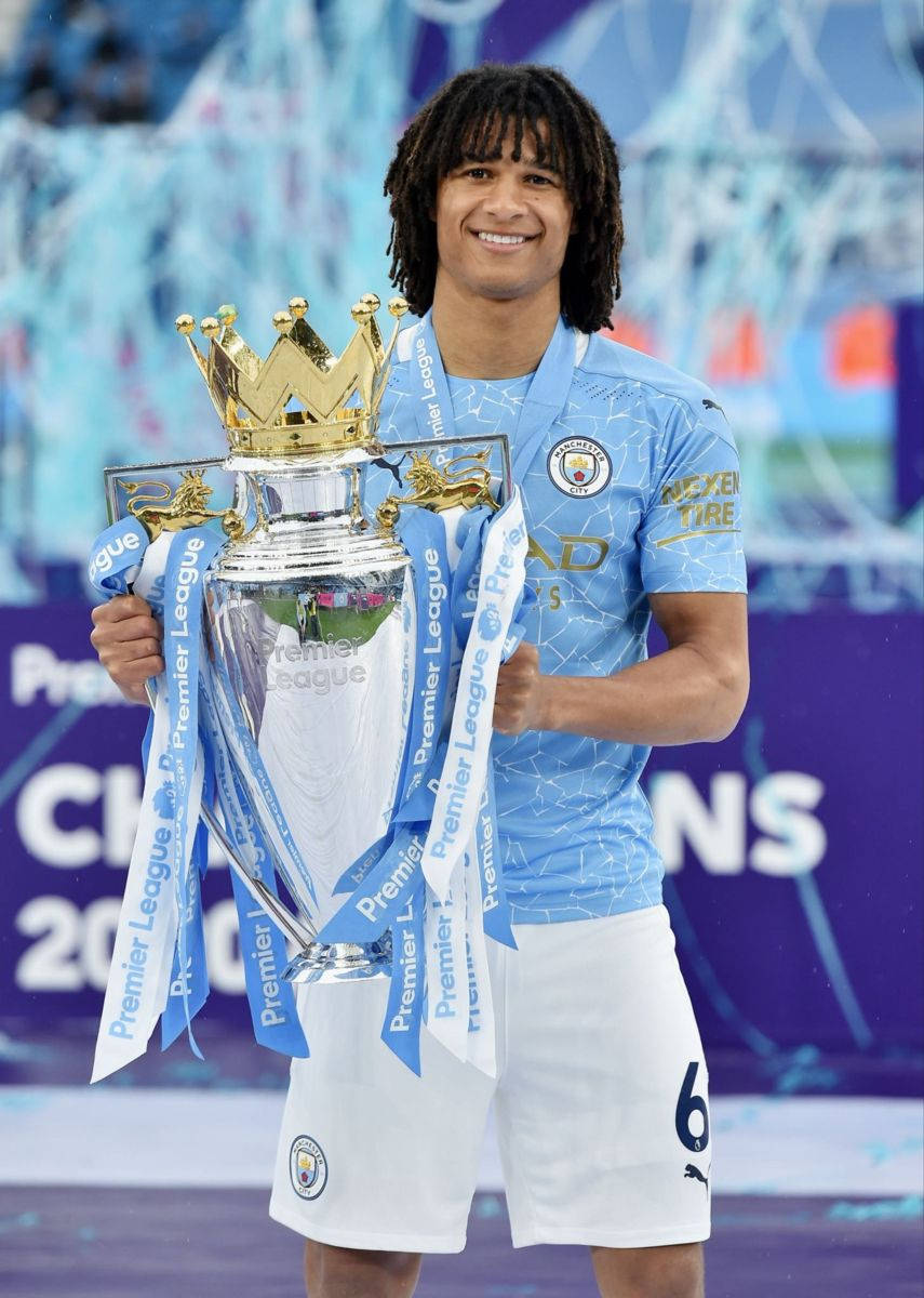 Manchester City Nathan Ake Holding Trophy Background