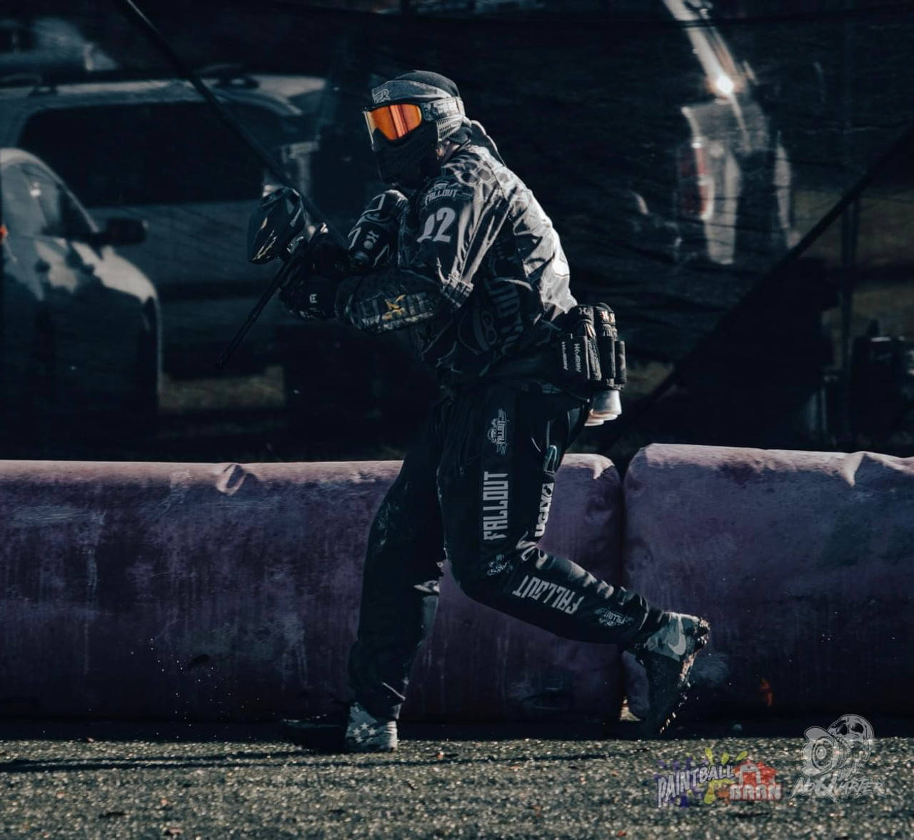 Maneuvering Paintball Player In Dark Colored Gear