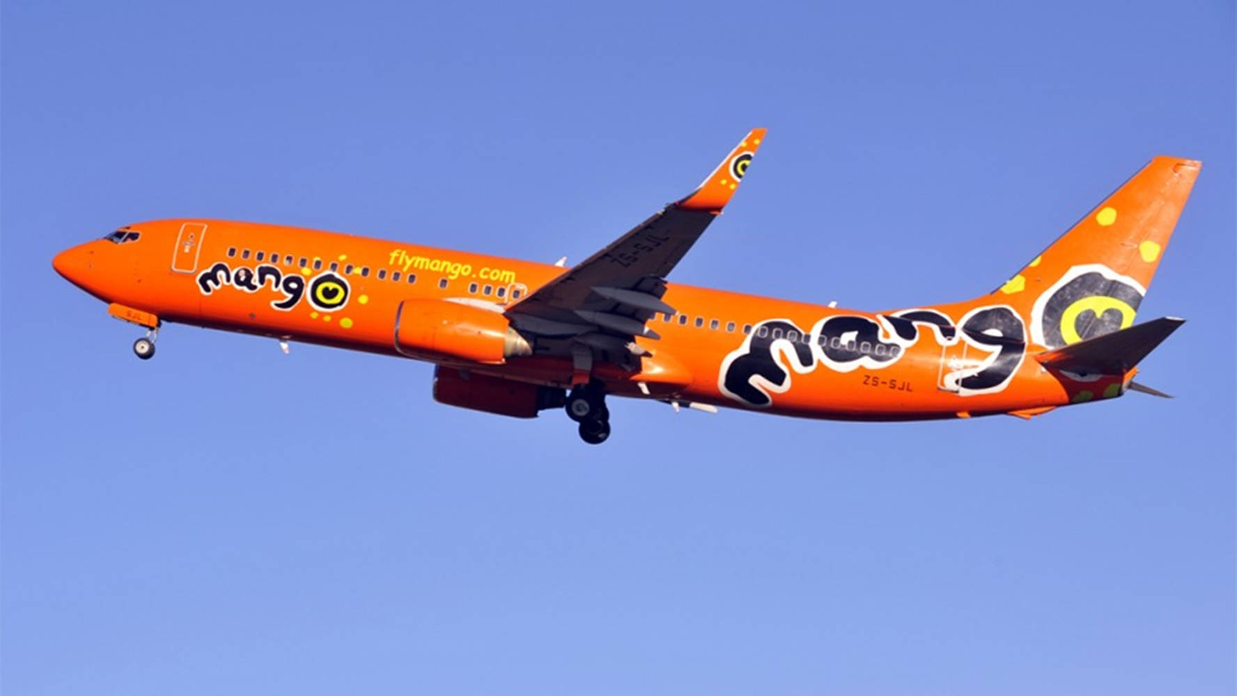 Mango Airlines Plane On Blue Sky Background