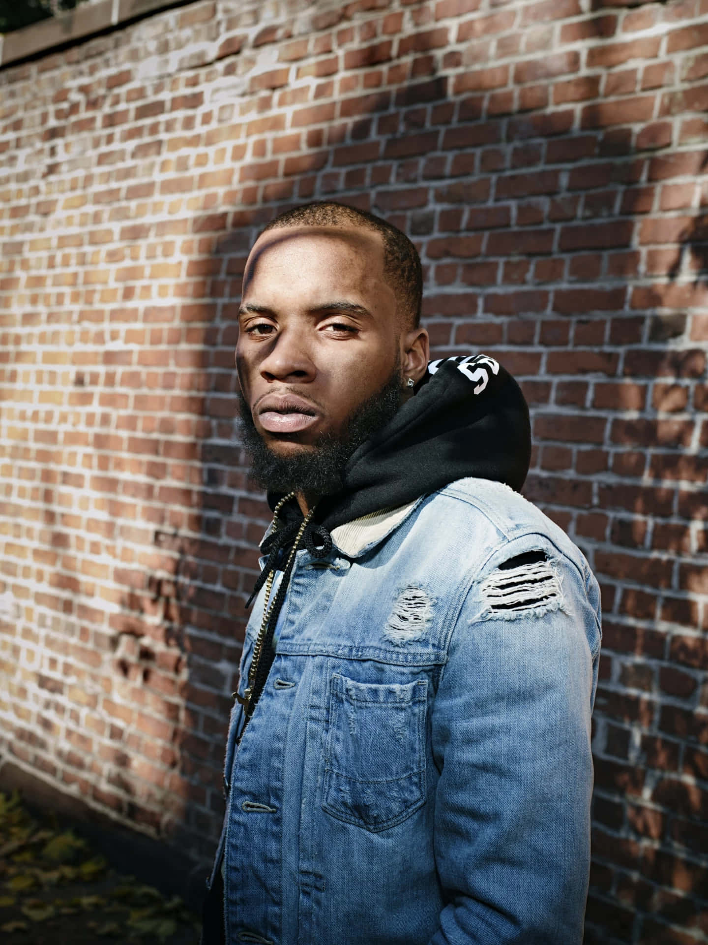 Manin Denim Jacket Against Brick Wall Background