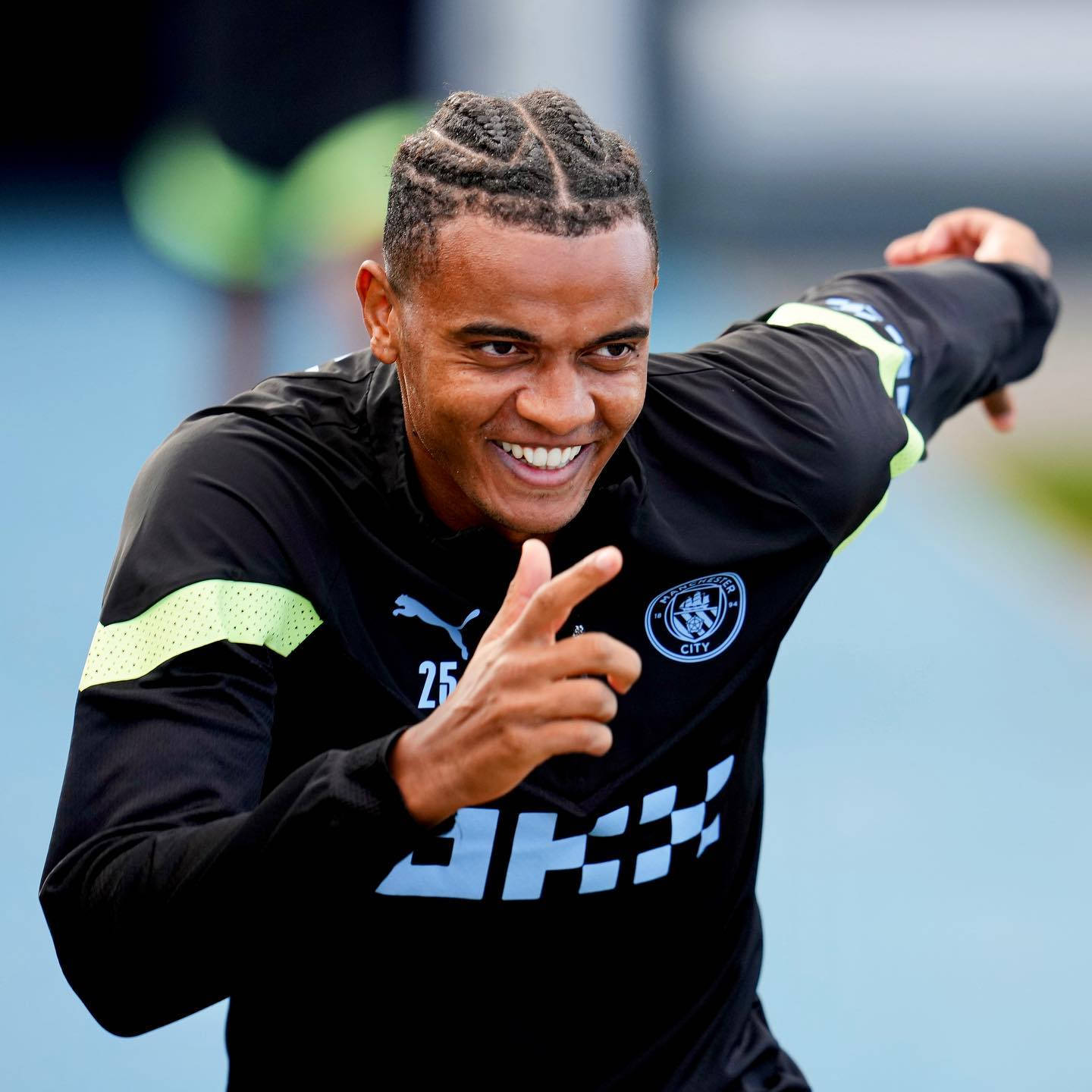 Manuel Akanji Cheerfully Pointing While Smiling During A Match