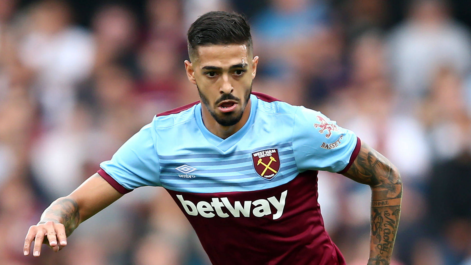 Manuel Lanzini Immersed In Playing Football Background