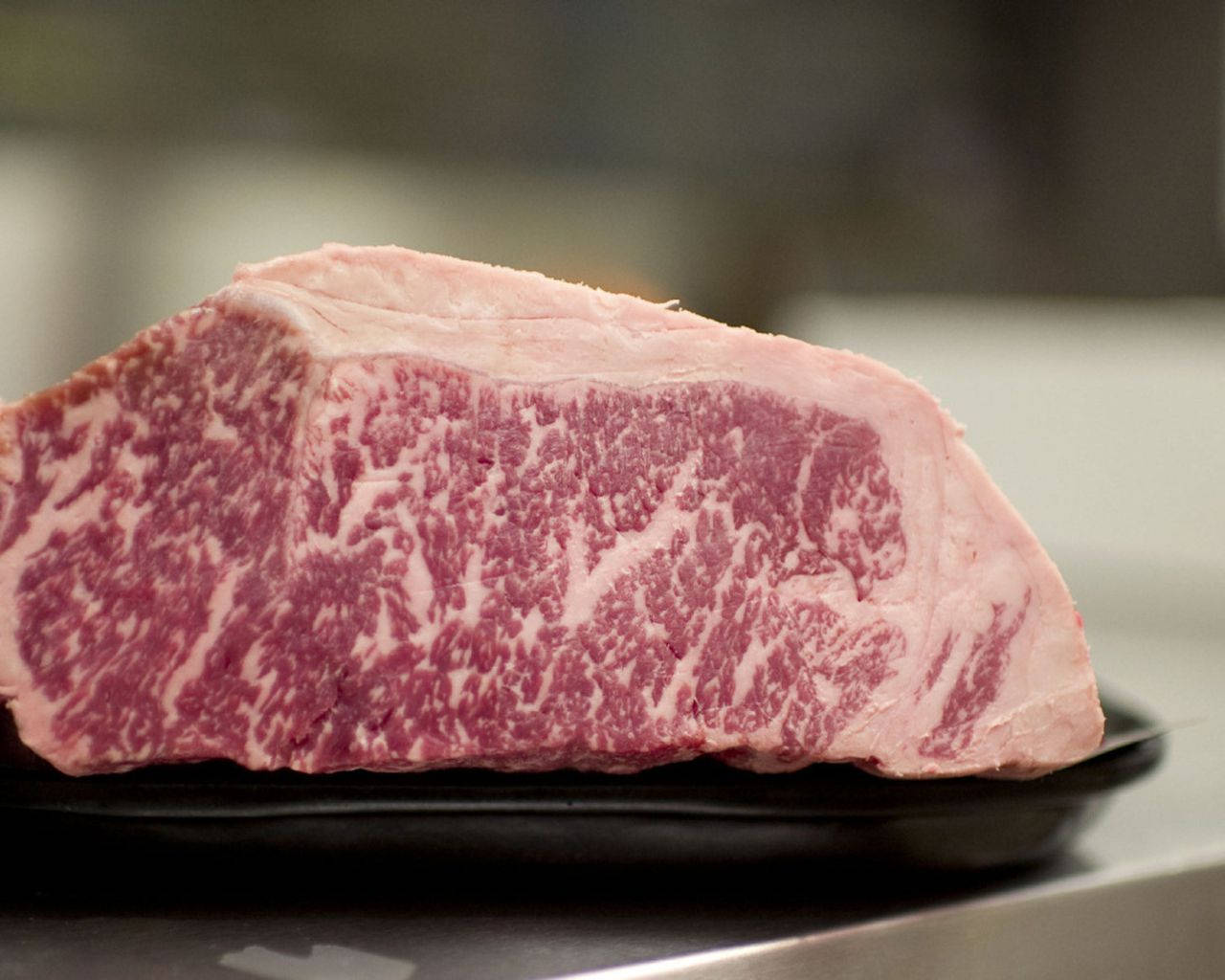 Marbled Kobe Beef On Black Plate Background